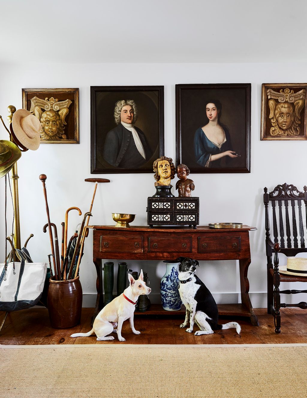 The family dogs Harriet and Lizzy in the entrance hall of antiques dealer Dana Jennings Rohn's house in Connecticut.