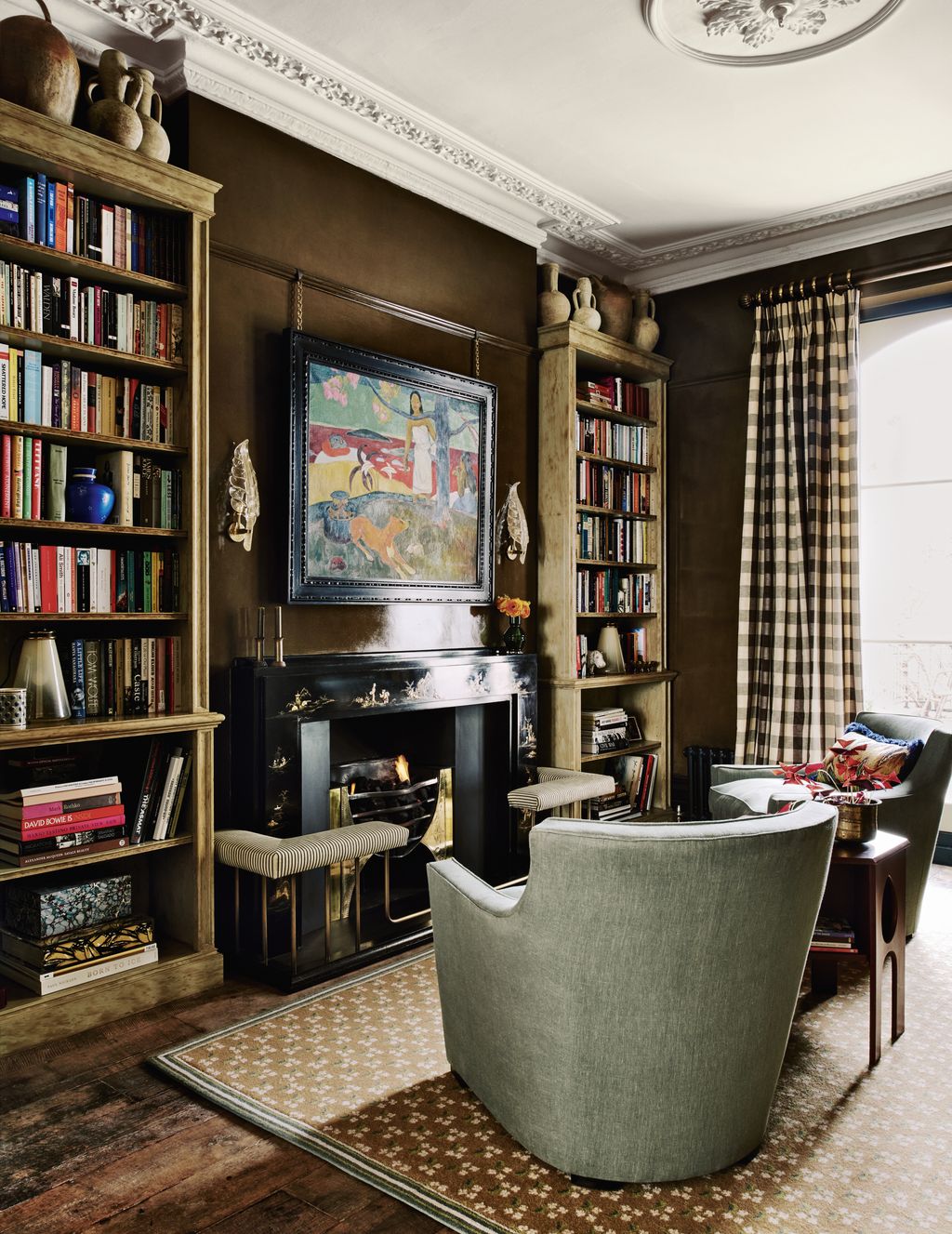 A pair of Howard tub chairs are complemented by a bespoke ‘Heartsease rug from Sibyl Colefax  John Fowler in the...