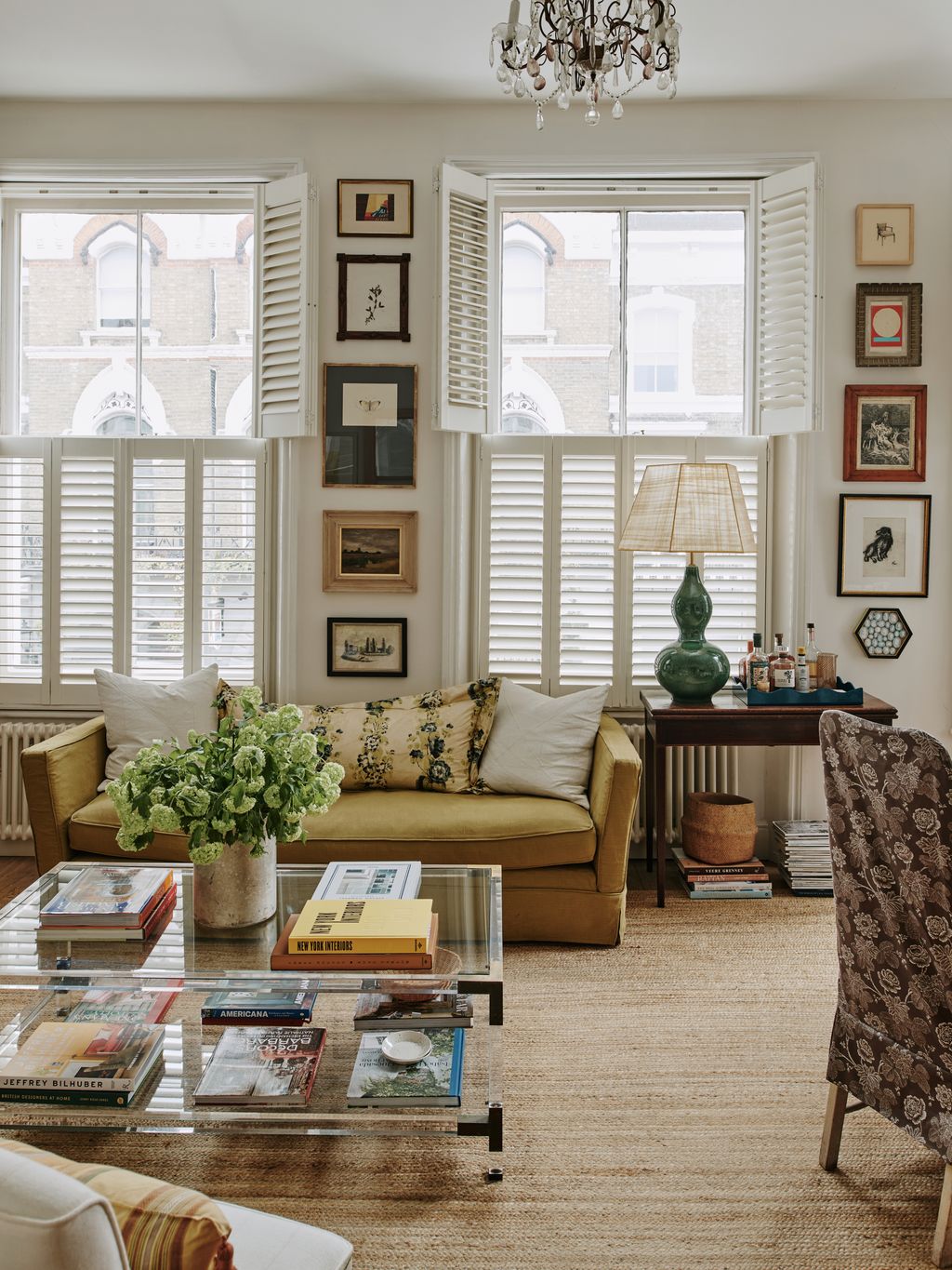 The main living area of Sally Wilkinson's rented flat. Sofa by Sofa Icon covered in a Claremont fabric lumbar cushion in...