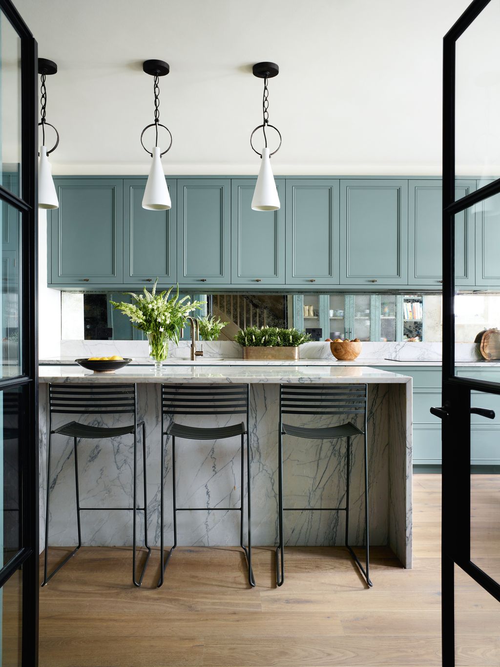 Designed by Chantel Elshout the kitchen has cabinetry in Little Greene Paint Papers ‘Livid. ‘Limoges pendants from...