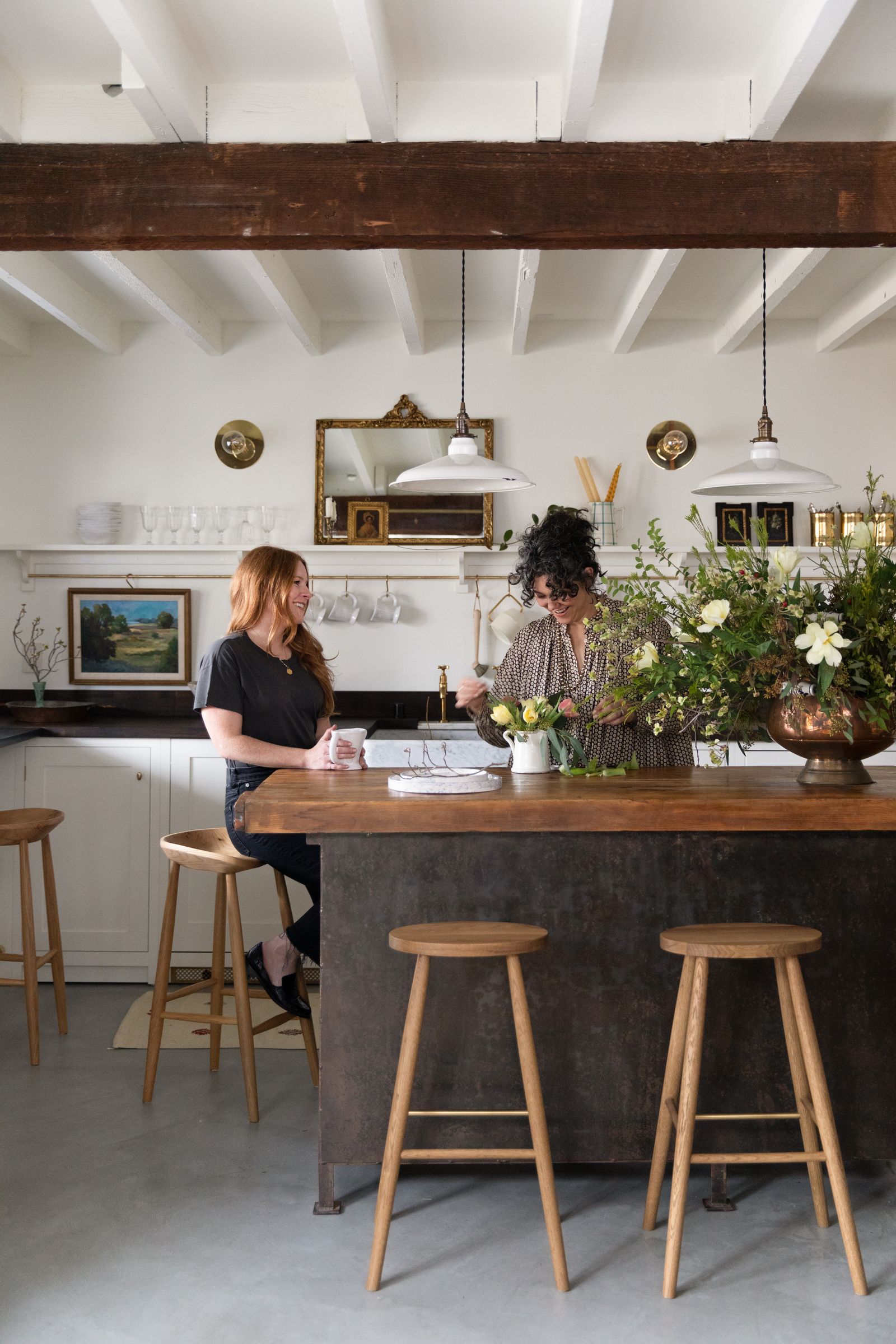 Hana and Jessica chatting in the kitchen.