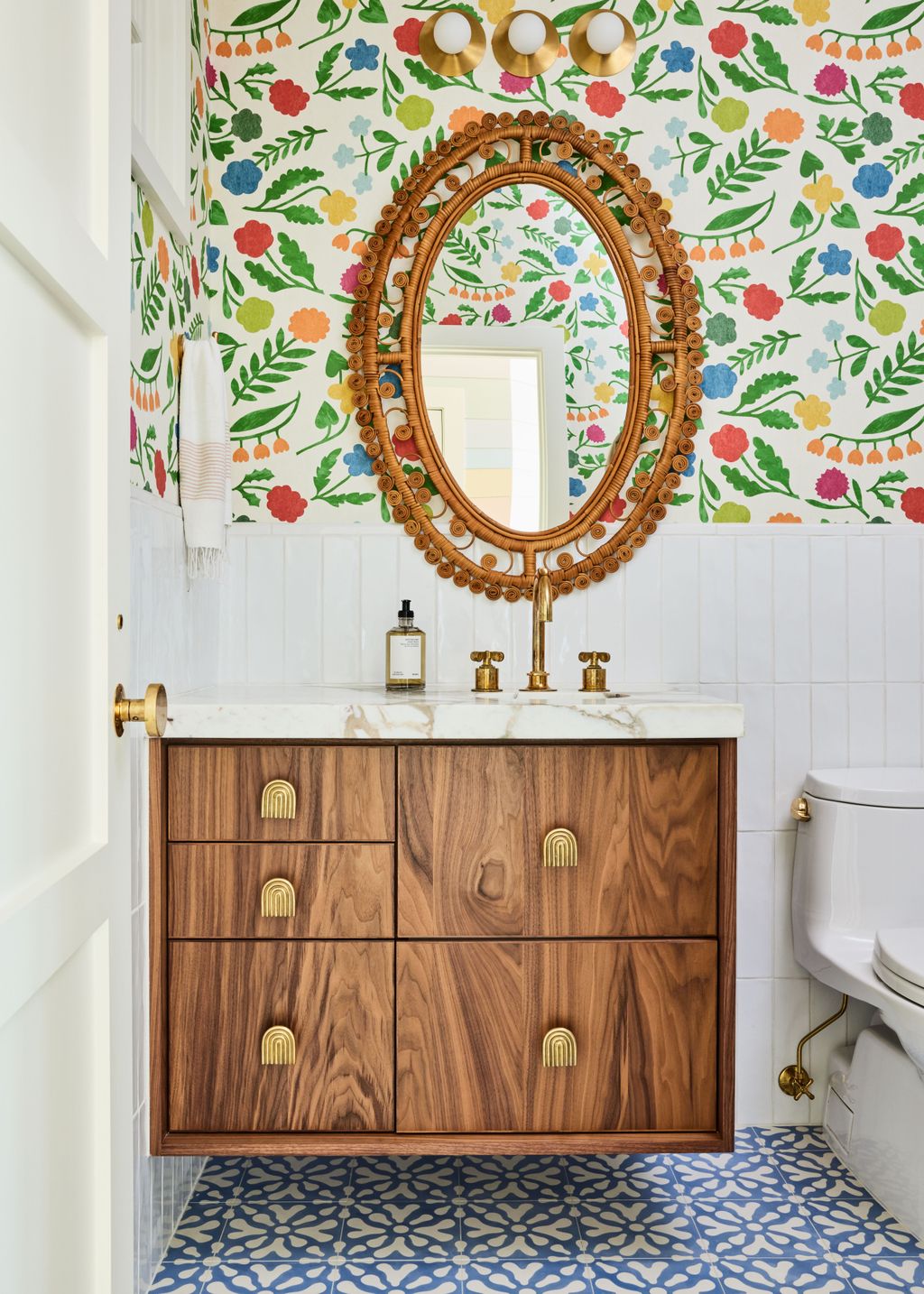 A cheerful wallpaper by Makoto Kagoshimanbspfor Christopher Farr Cloth makes this powder room shine.