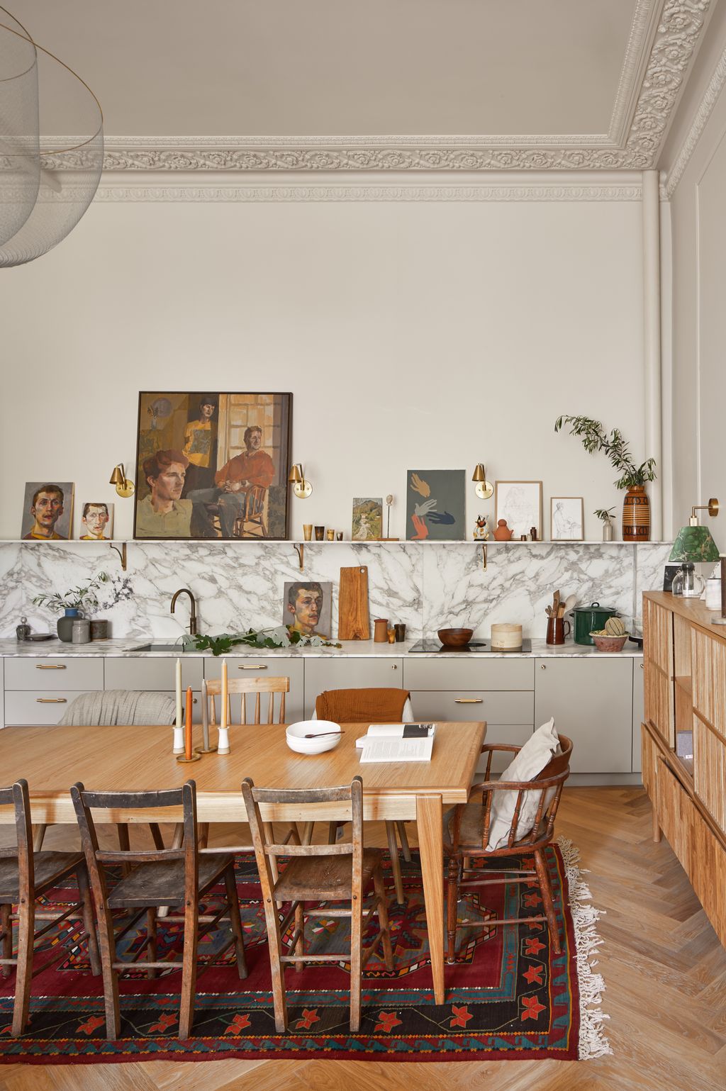 The shelf above the counter is used as a space to display art and ceramics.