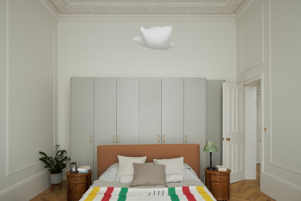 A bed from Heals is placed in the centre of the room creating a separate ‘dressing area between the bed and the large...