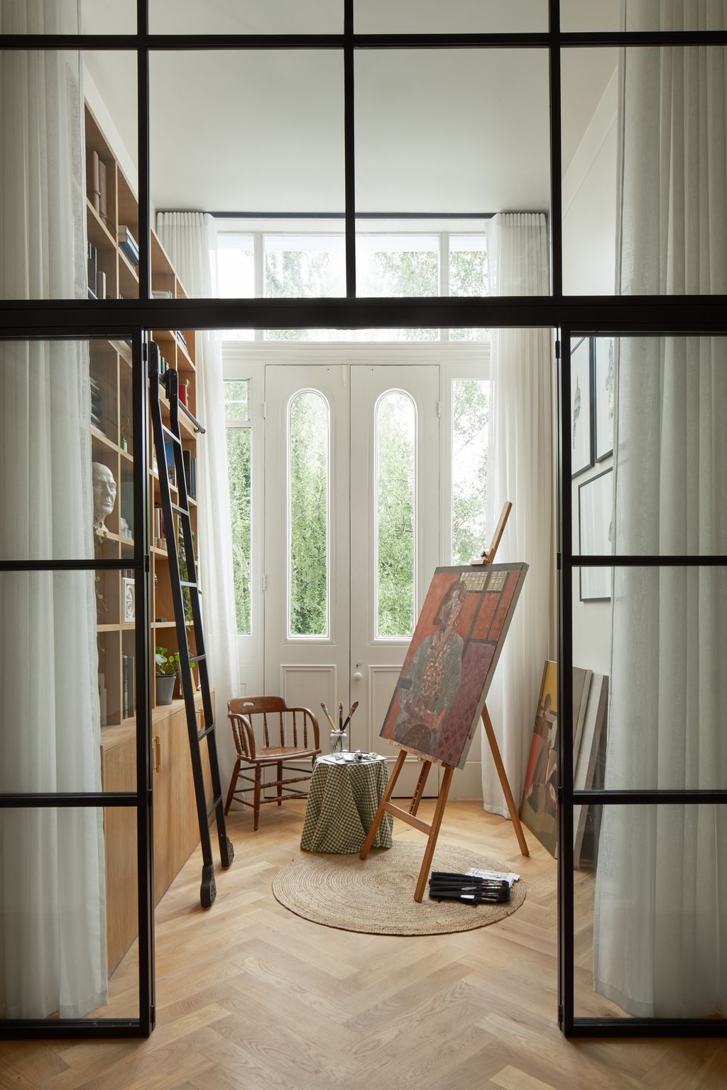 Crittal doors into the new art studio allow light to flood the hallway.