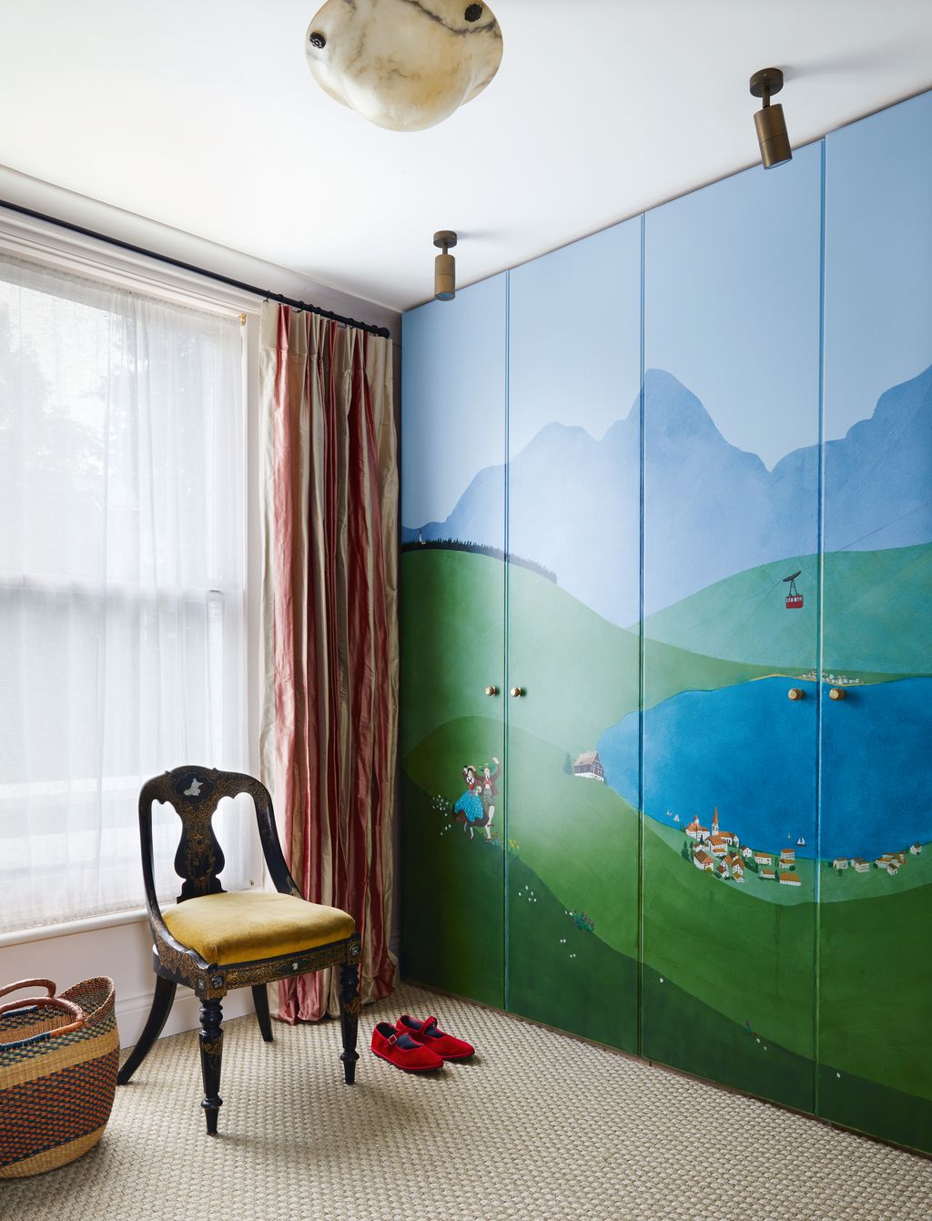 The wardobes in this London house by Rachel Chudley are decorated with a mural inspired by the owners childhood memories...