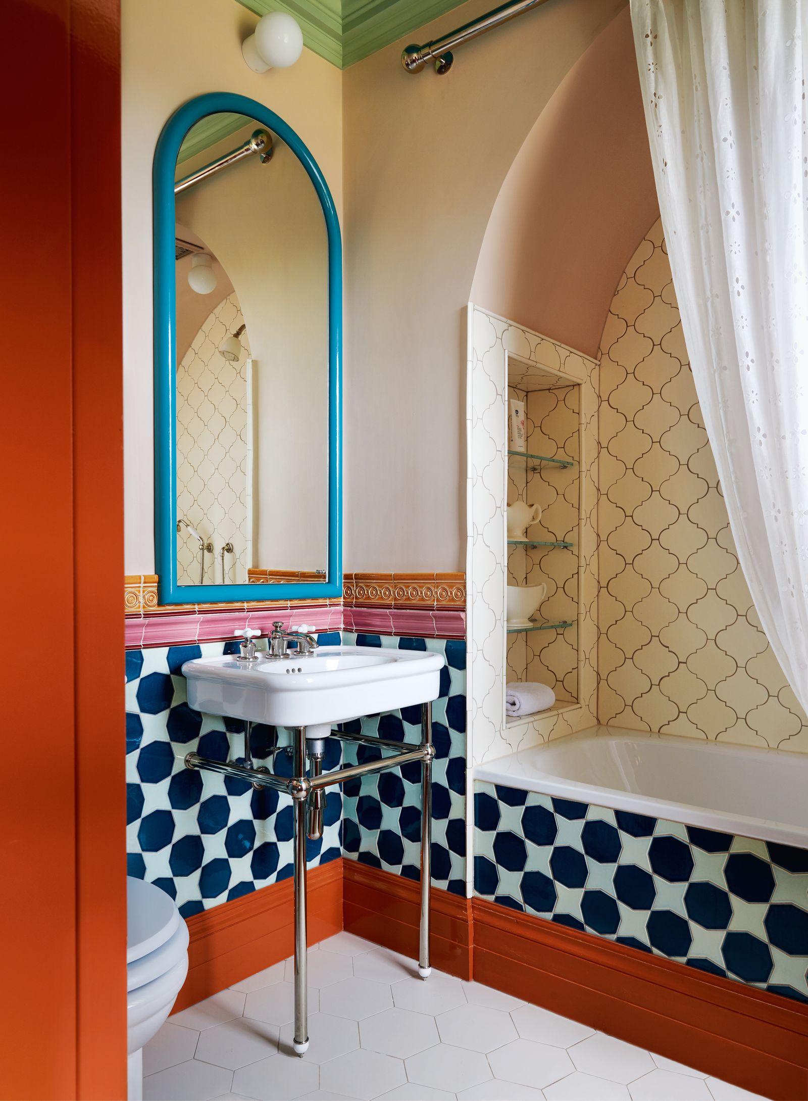A tiled bath makes an impact in the bathroom of a country house by Henri Fitzwilliam Lay.