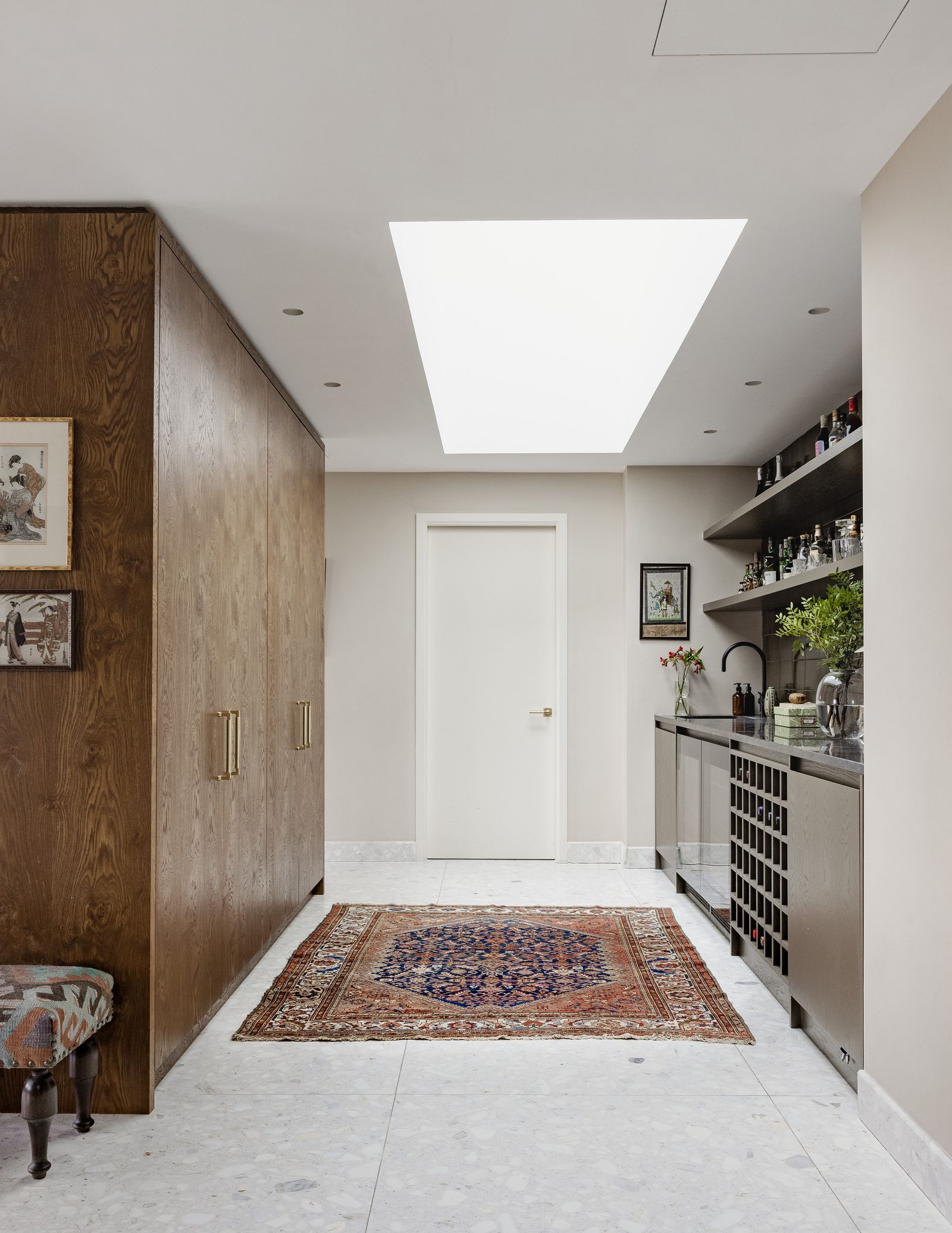 The entrance hall has been separated from the rest of the flat using bespoke joinery. Lishan installed a bar area into...