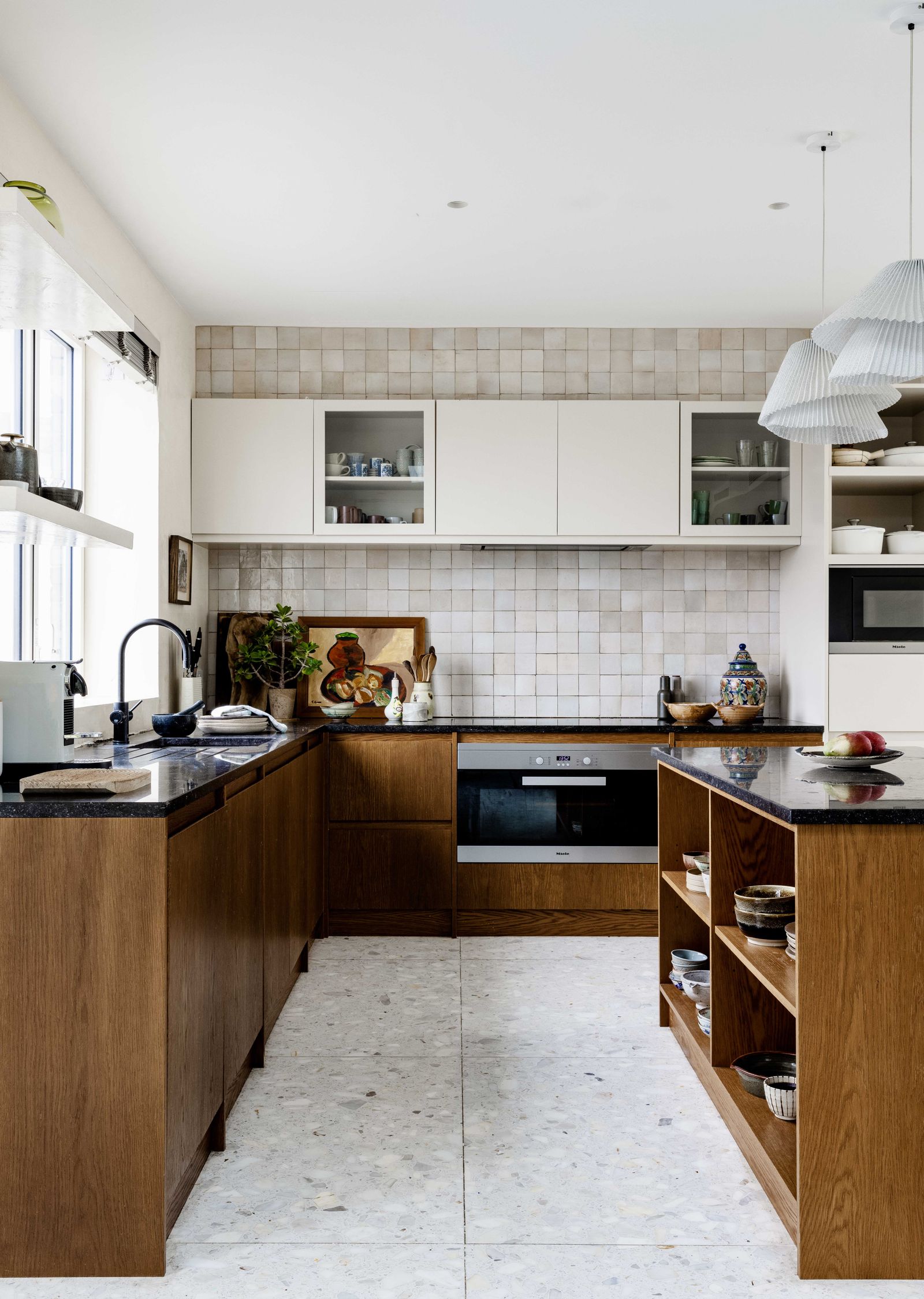 In the kitchen wooden cabinets and zellige tiles add texture.