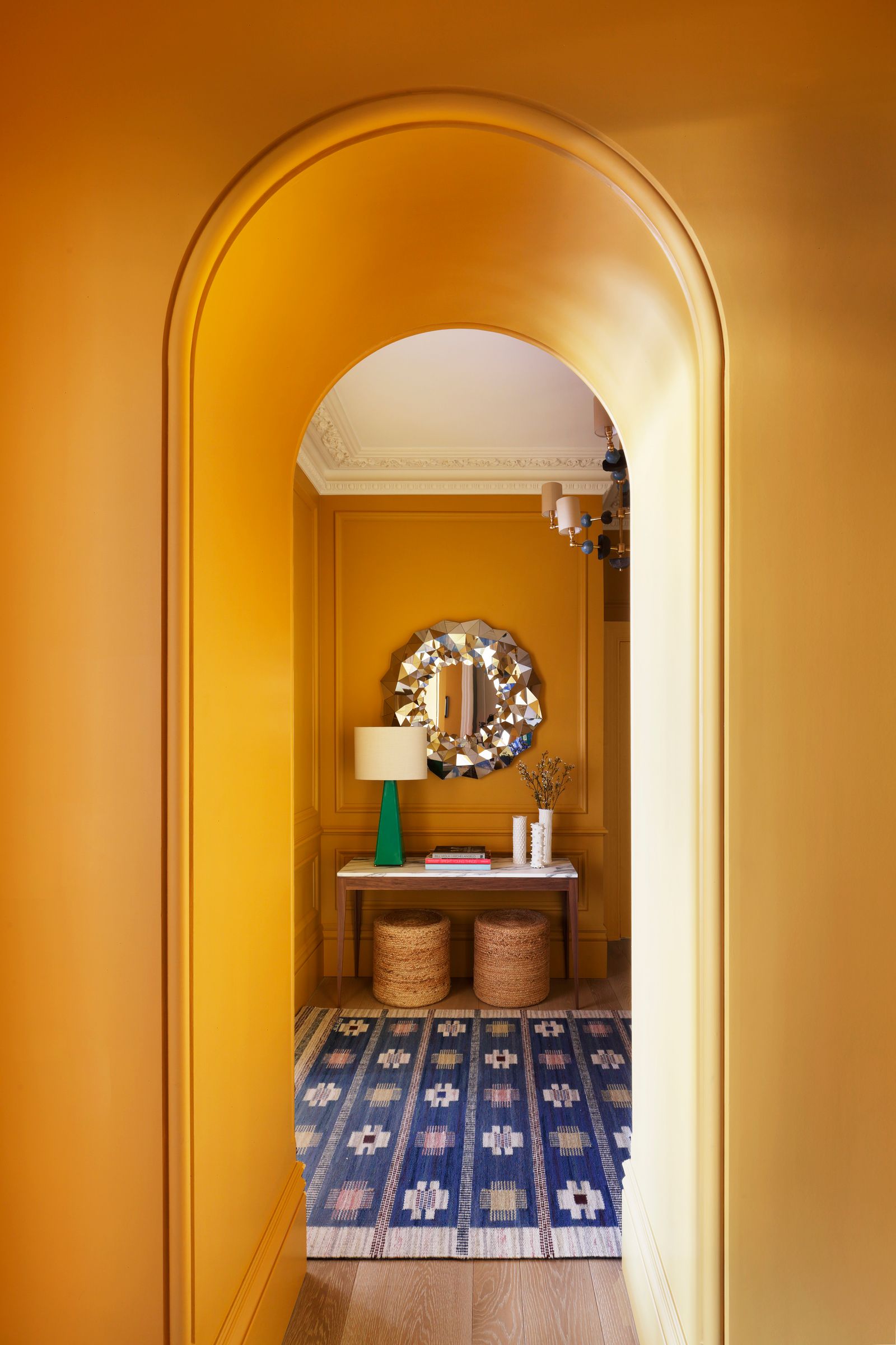 This hallway in a London piedàterre by Studio Peake had no natural light but ‘Terre Jaune by Argile lends a sense of...