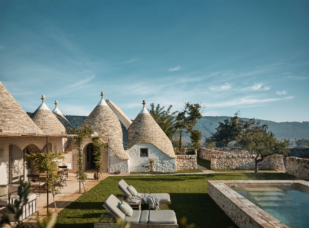 The landscape of Puglia is dotted with traditional masserias characterised by spherical trulli buildings with grey...