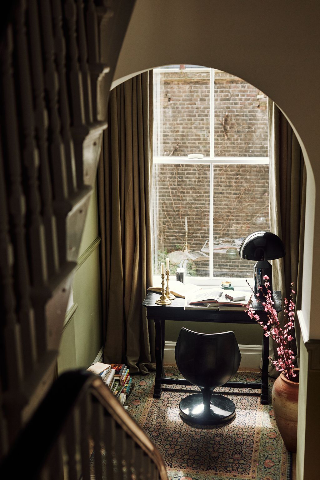 At the top of the stairs a cosy office nook is the perfect spot to work. The carpet is from Howe London the desk is from...