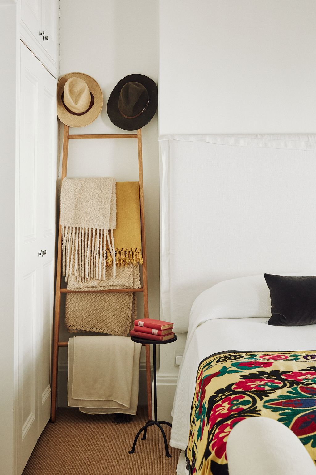 In Juana's bedroom  a little iron table from Zara Home acts as a smart bedside table. The headboard is from Rue Vintage...