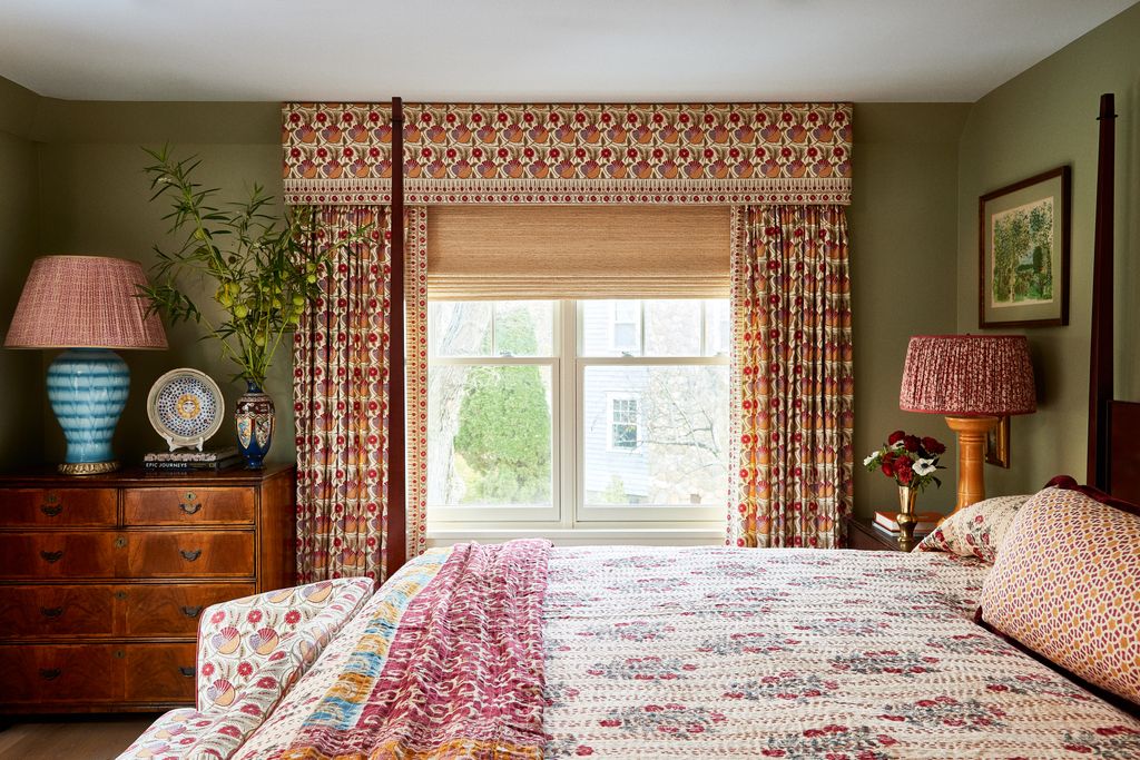In the guest bedroom walls in Sherwin Williams' ‘Sage are the perfect backdrop for the curtains bed and sofa covered in...