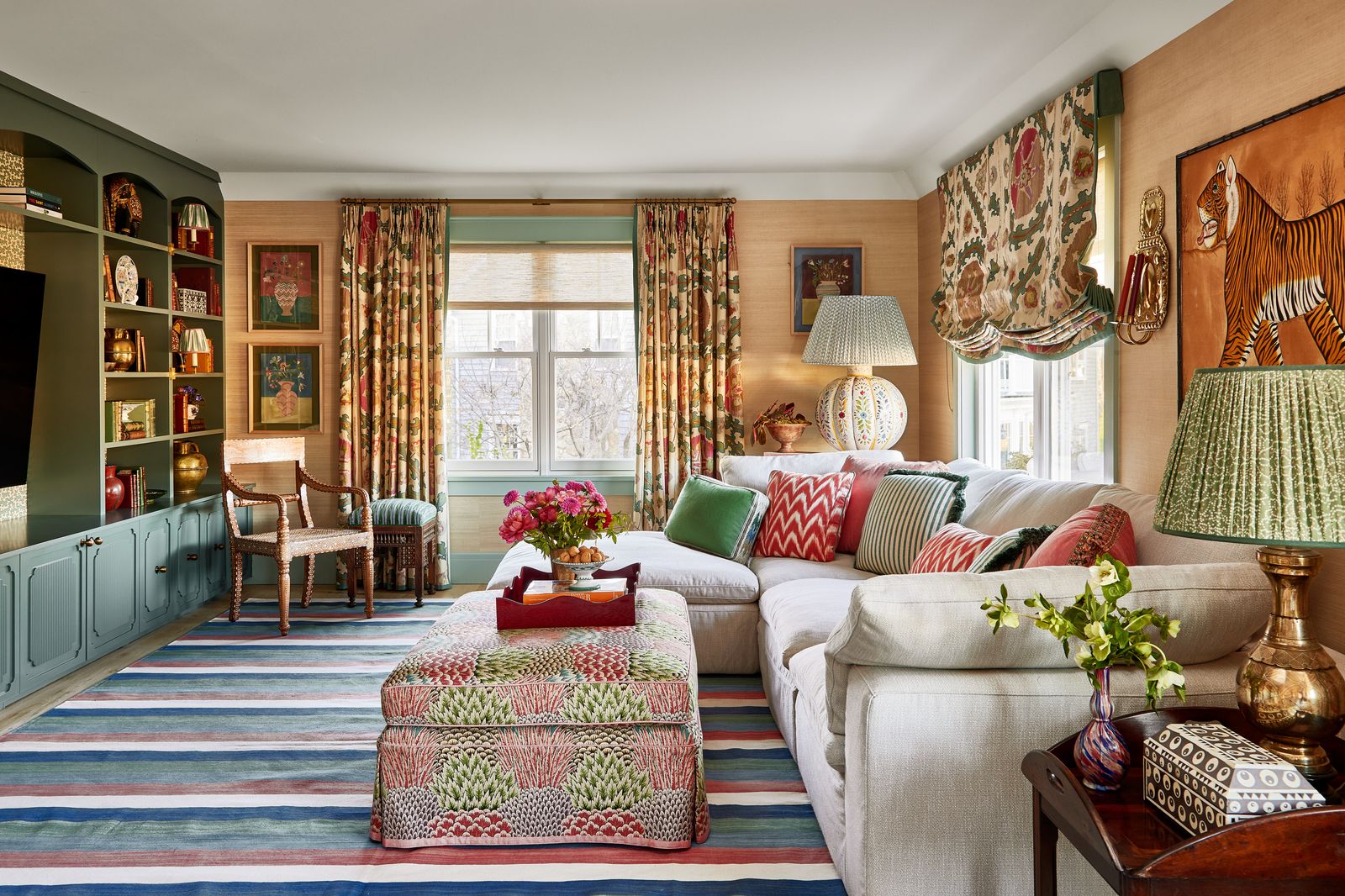 In the sitting room a grasscloth wallcovering by Phillip Jeffries adds texture to the scheme while the curtains and...