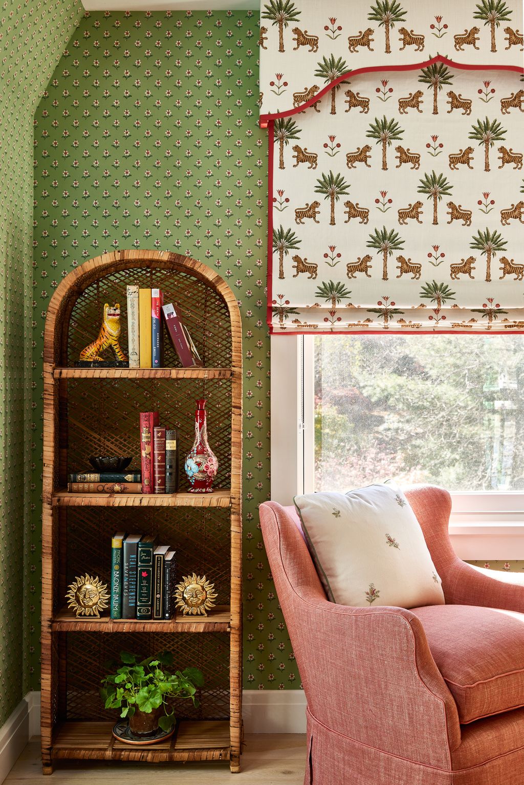 The blind is in Schumacher's ‘Tiger Palm fabric. A plain linen from Fermoie covers the armchair.