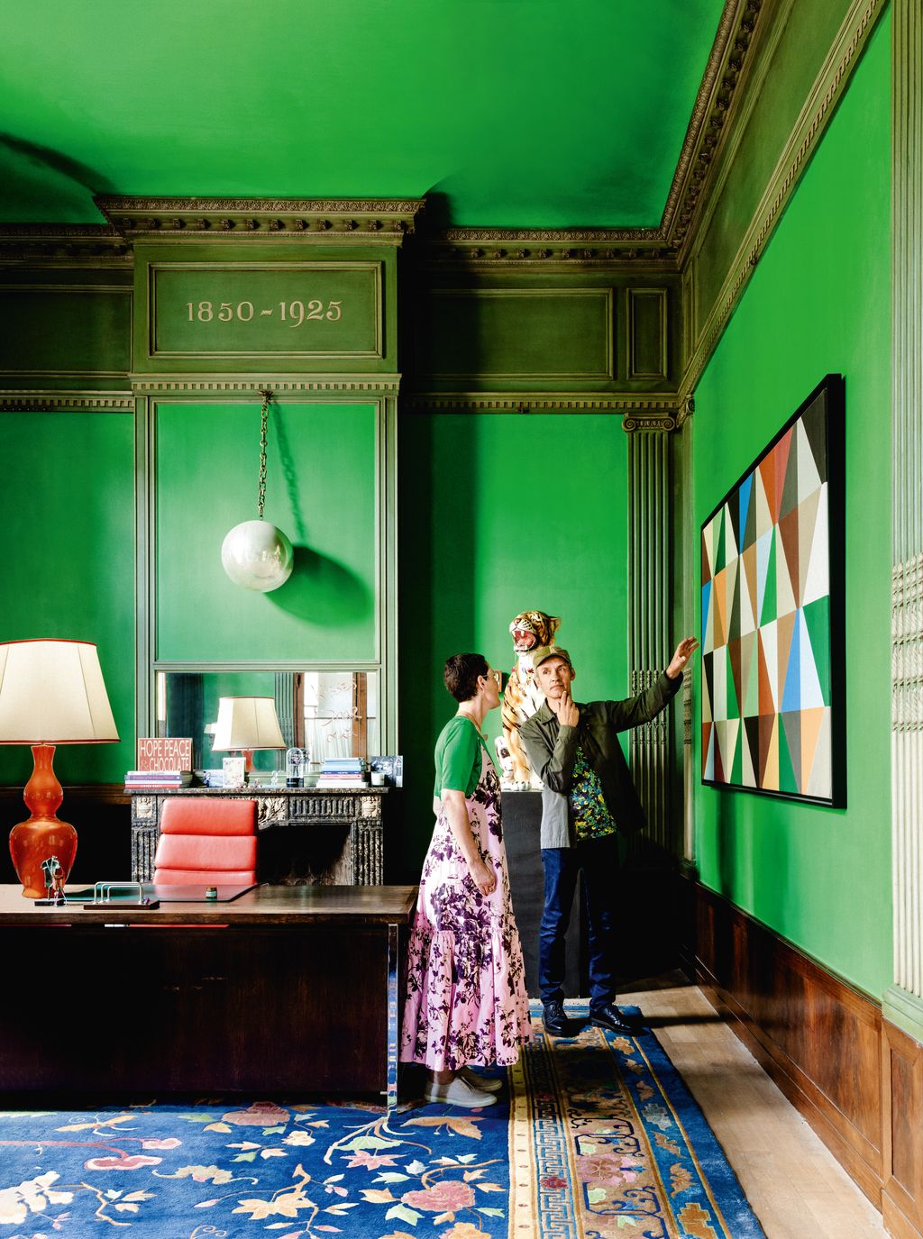 The couples painting is set off by the vibrant green walls of Inge Onseas office designed for her by JeanPhilippe...