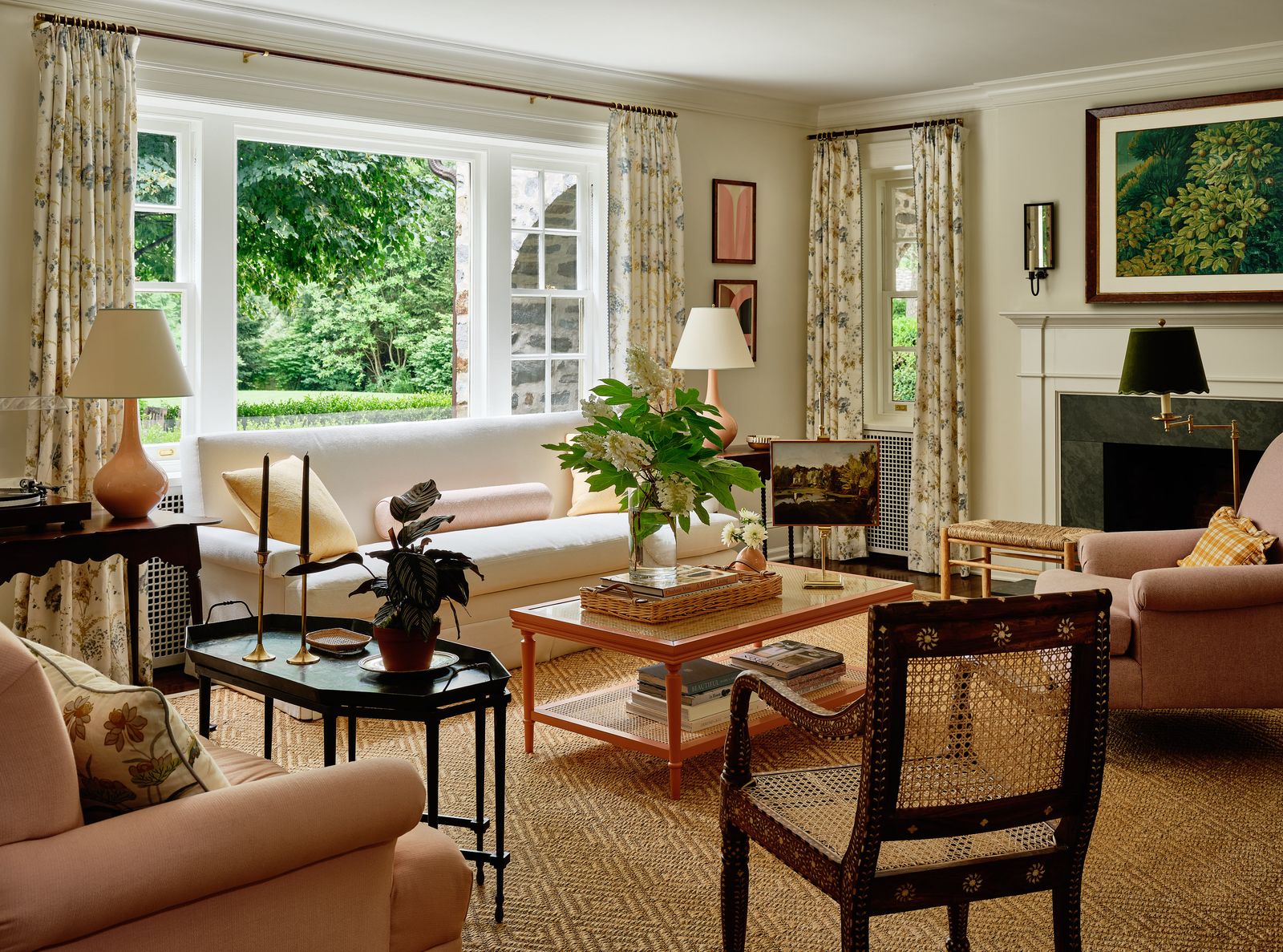 The living room features many large picture windows each of which have stunning views onto the house's verdant gardens....