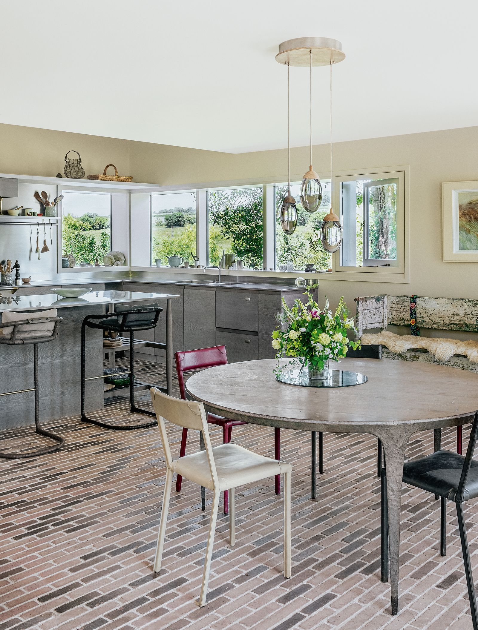 The brick floor and an old Swedish bench from Dairy House Antiques in Semley provide a textural contrast with a sleek...