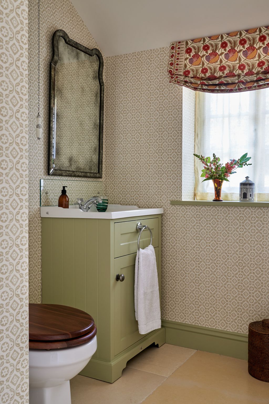 In the downstairs powder room walls are covered in Donatello” by Nicholas Herbert the vanity is painted in “Ball Green”...