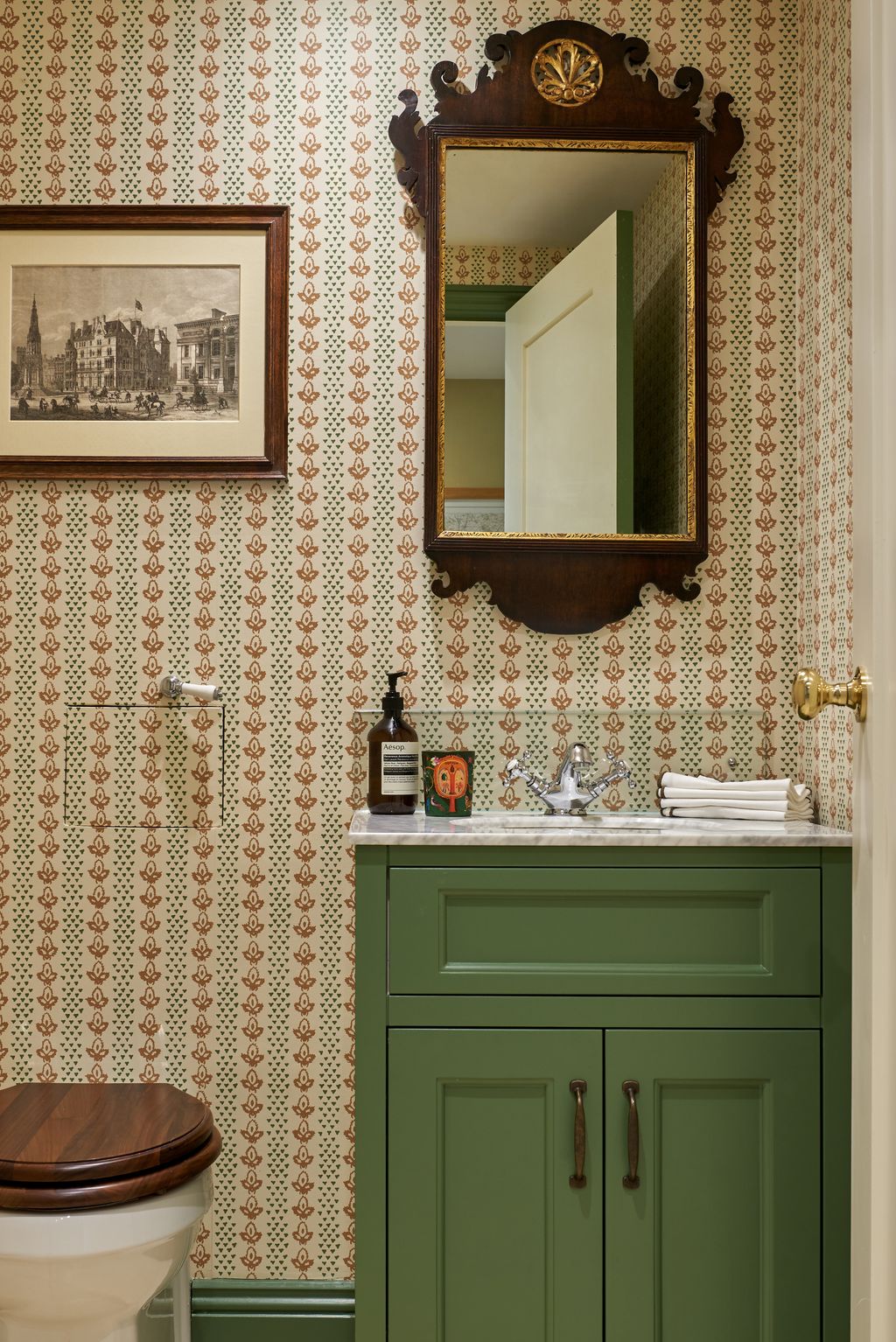 The boot room loo is covered in the “Bees” wallpaper by Sibyl Colefax  John Fowler the vanity was painted in “Calke...