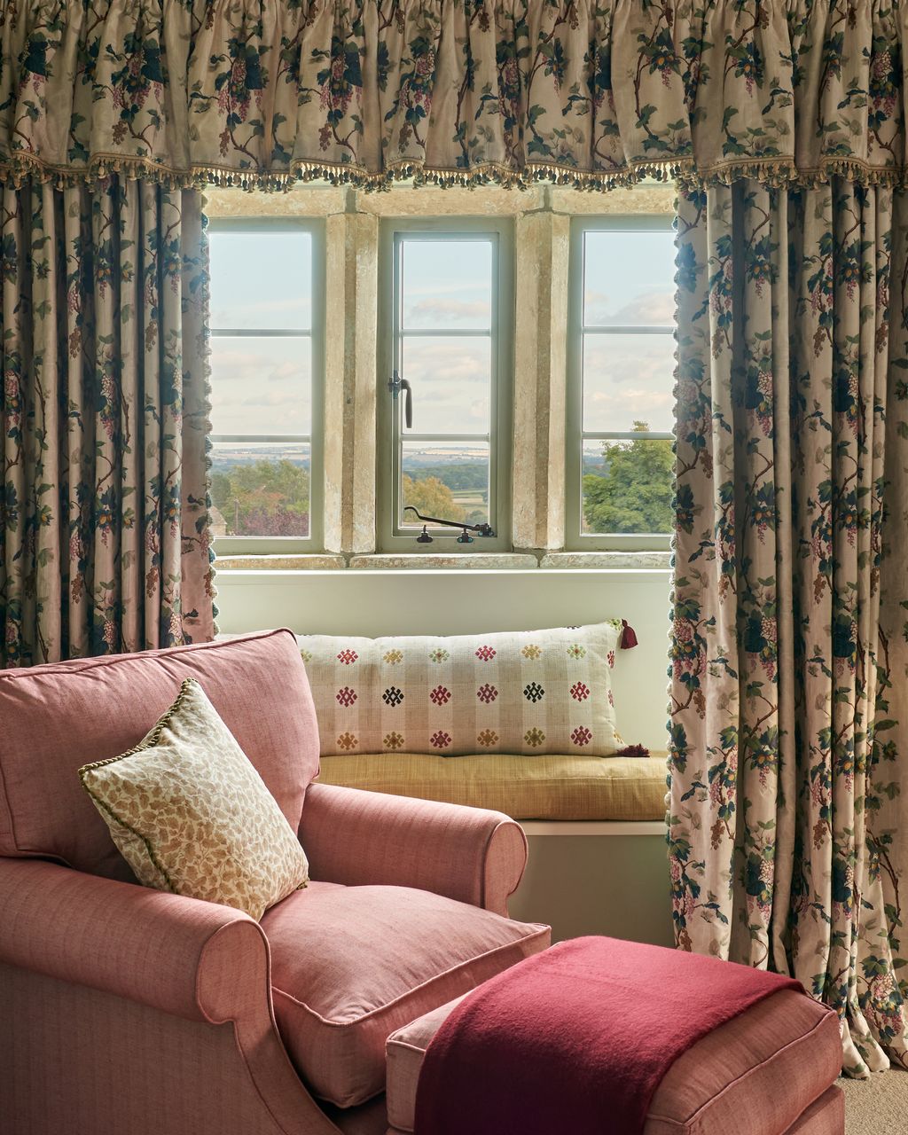 The small reading nook in the master bedroom features a pink armchair by David Seyfried and is upholstered in Old Flax...