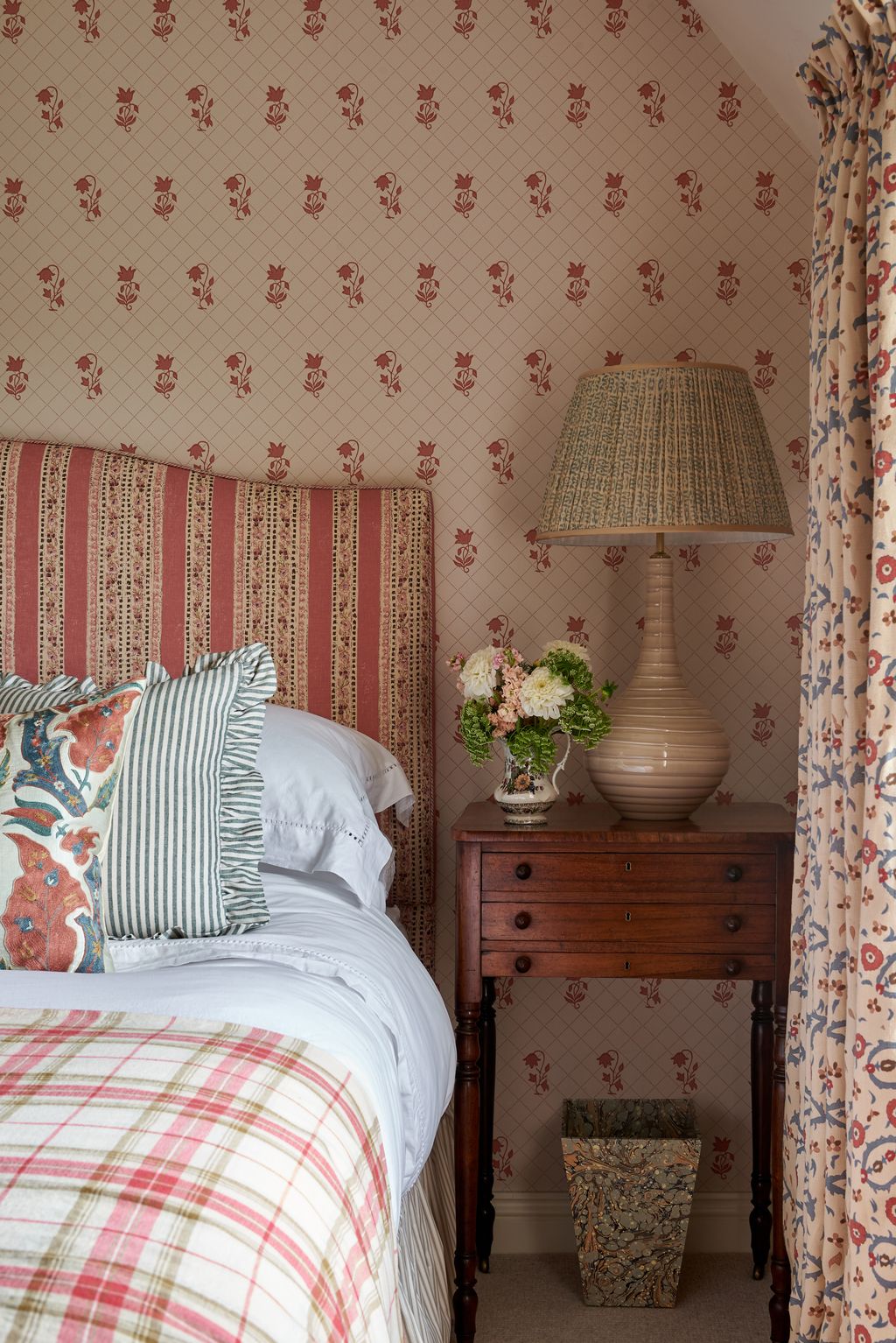 In another bedroom the walls are covered in a light pink patternednbspwallpaper “Berkeley Sprig” by Colefax  Fowler. The...