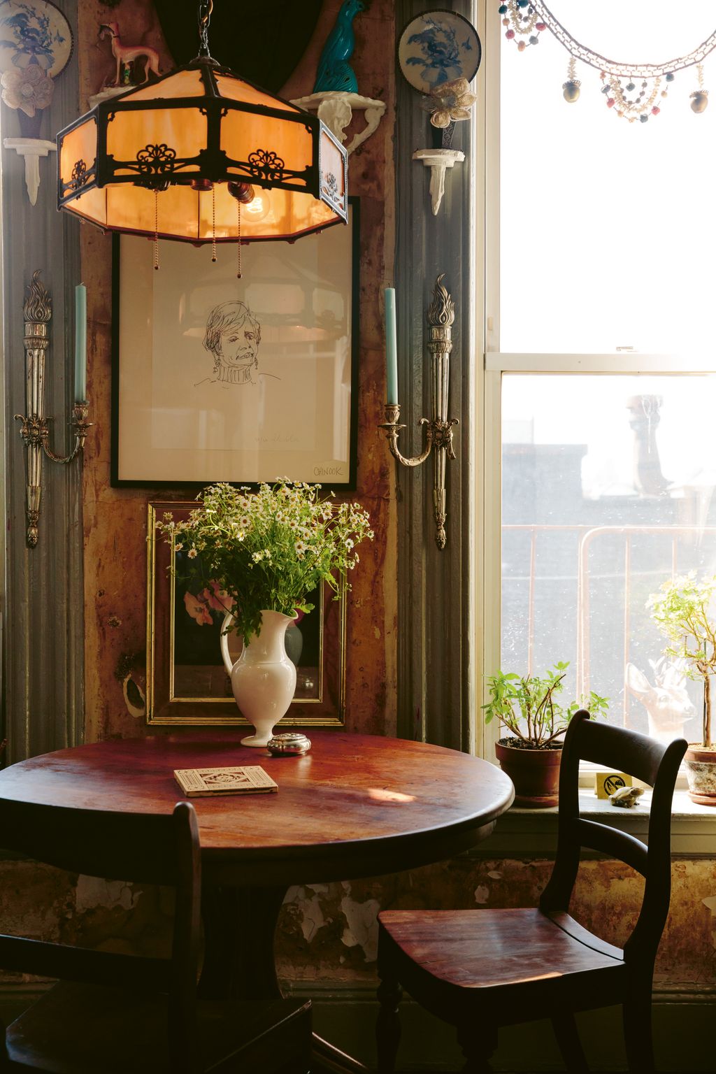 An eclectic mix of antique and vintage pieces furnishes the rooms of their home.  buttongroup  See the full house