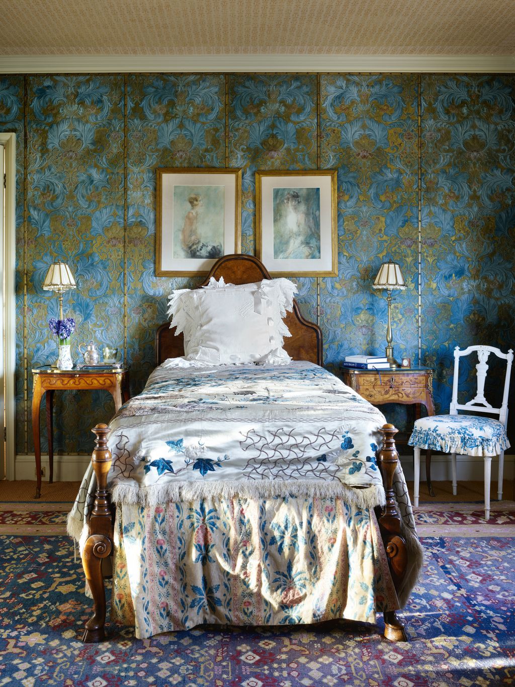 A Lincrusta wallcovering in atmospheric greens and blues picks up on the colours in two portraits by Arthur Ambrose...