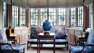 A Chippendale sofa and chairs upholstered in a c1760 Mortlake tapestry surround a 19thcentury Chinese flower stand...