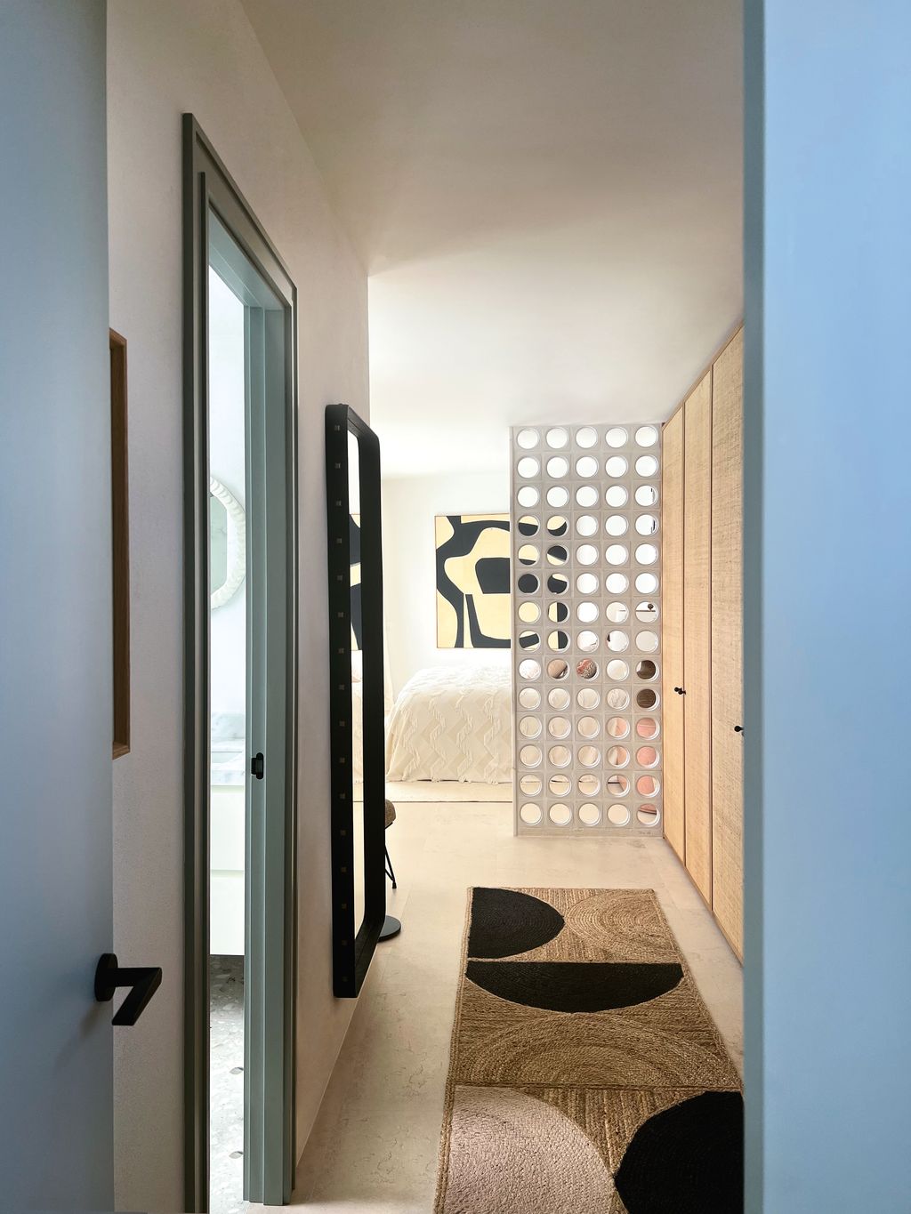The bedroom of this villa on Menorca designed by Anna Standish has a door but the designer chose to add a divider. This...