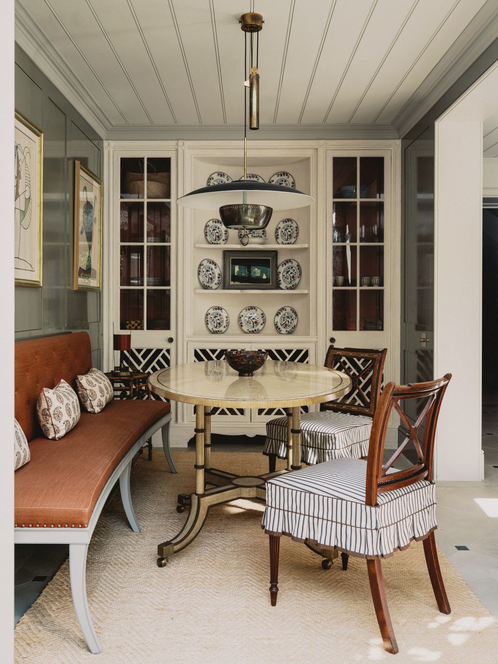 Another angle of the dining room shows the curve of the bespoke banquette which is covered in Verandah by Veere Grenney...