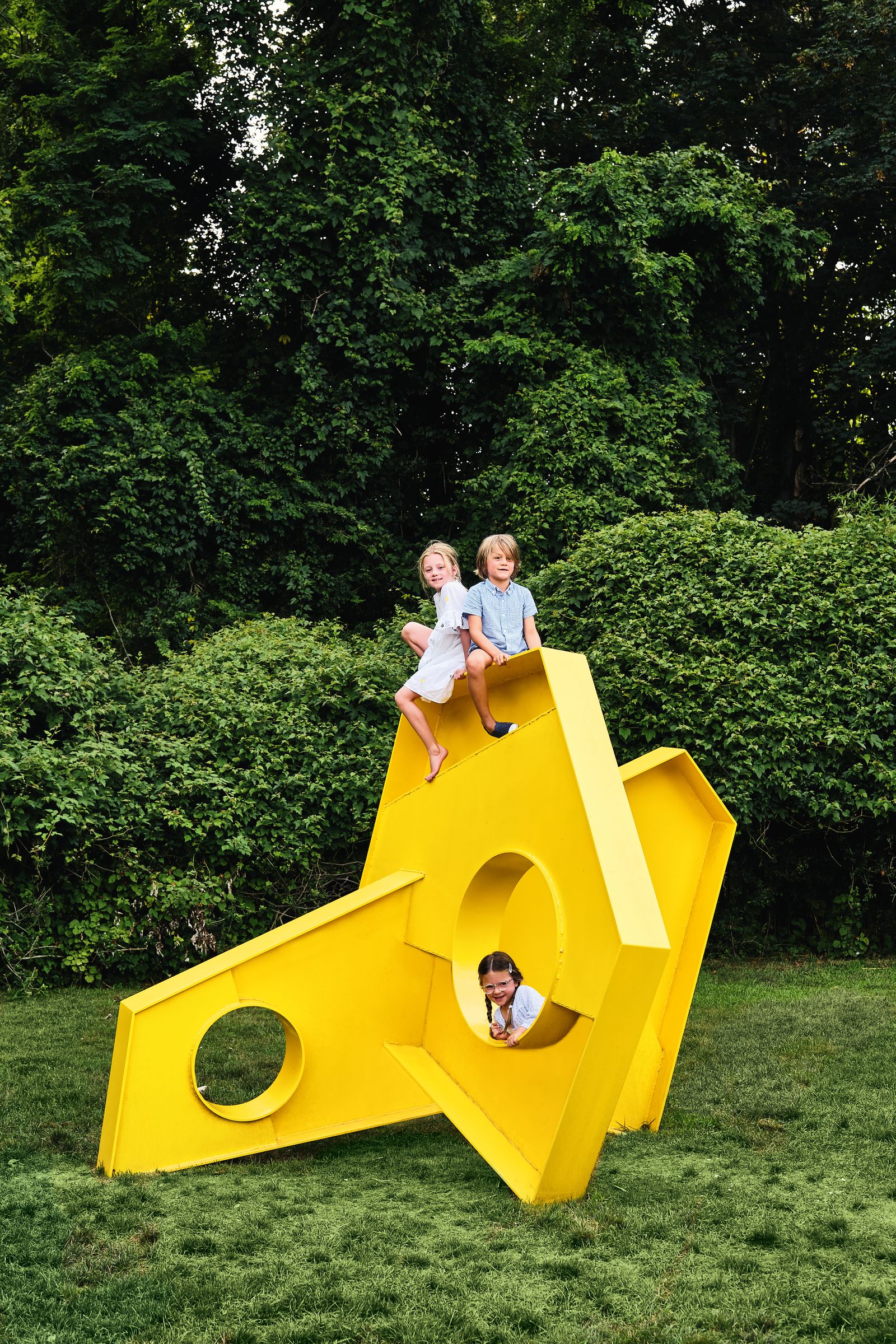 Charlotte and friends climb on his Recess Tap amp Pointe sculpture