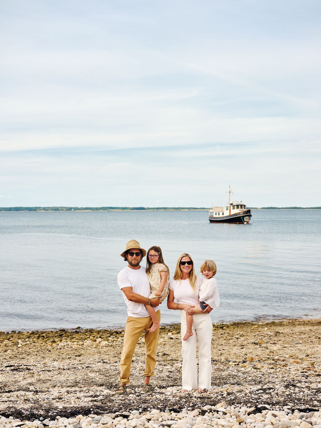 Fitzhugh and Lyndsay with their children Charlotte and Fitzhugh at the bottom of their garden on the shore of Gardiners...
