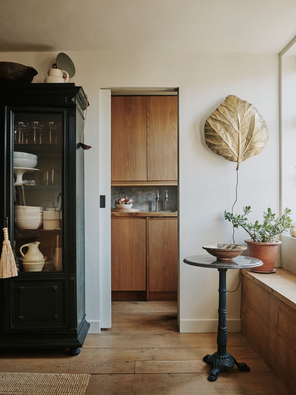 The leaf lamp on the wall is a vintage piece from Tommaso Barbi and the tiger table is from Fontaine Decorative.
