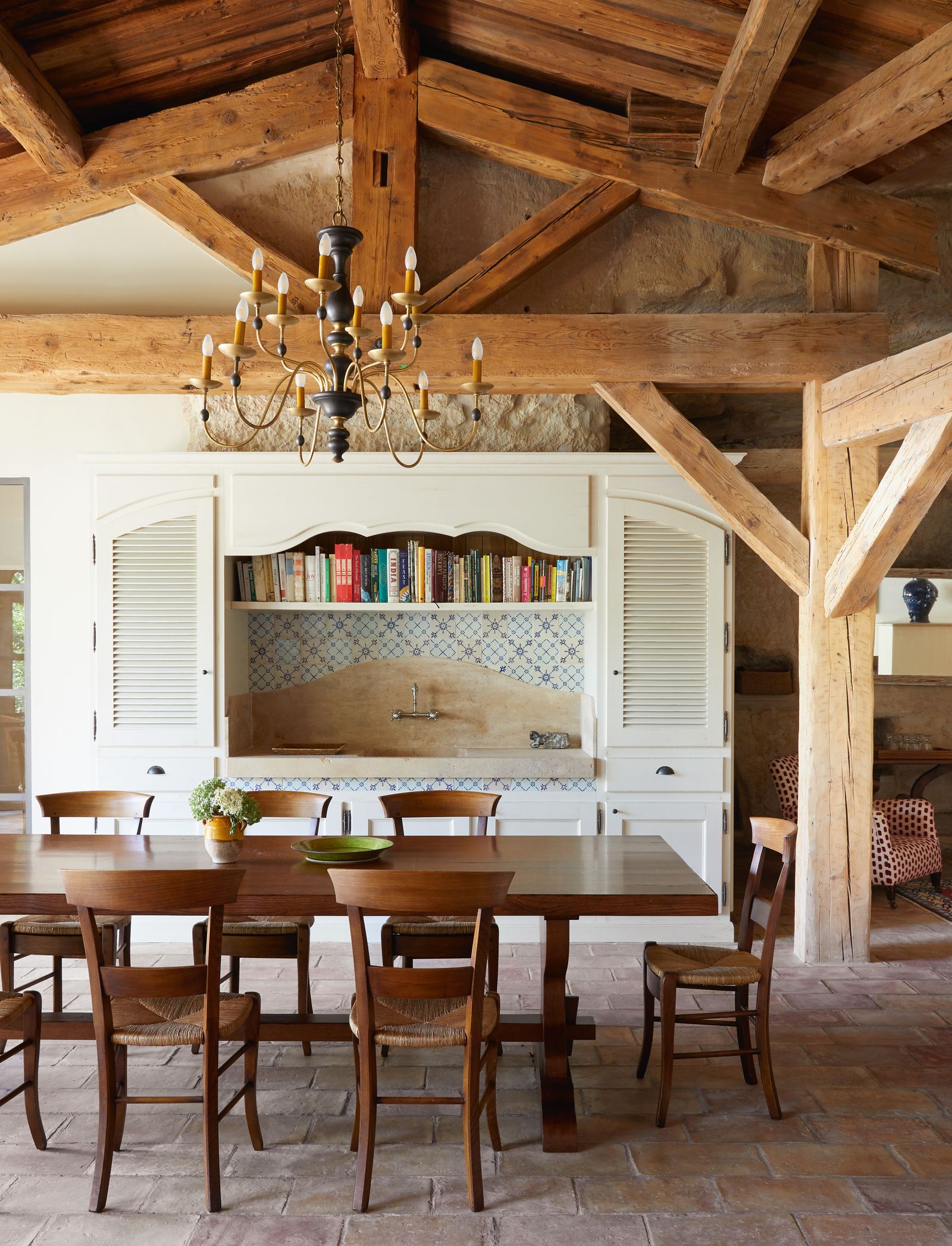 A table made by local craftspeople at Atelier de la Boiserie is partnered by chairs from Chaises Lacroix in...