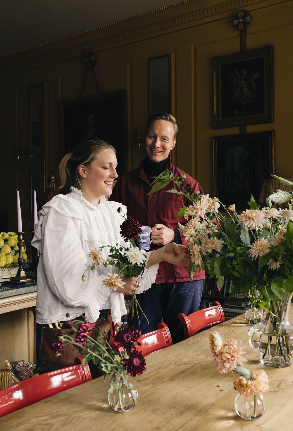 Milli with Martin Brudnizki arranging dahlias for an event at the interior designers country house nearby in Sussex.