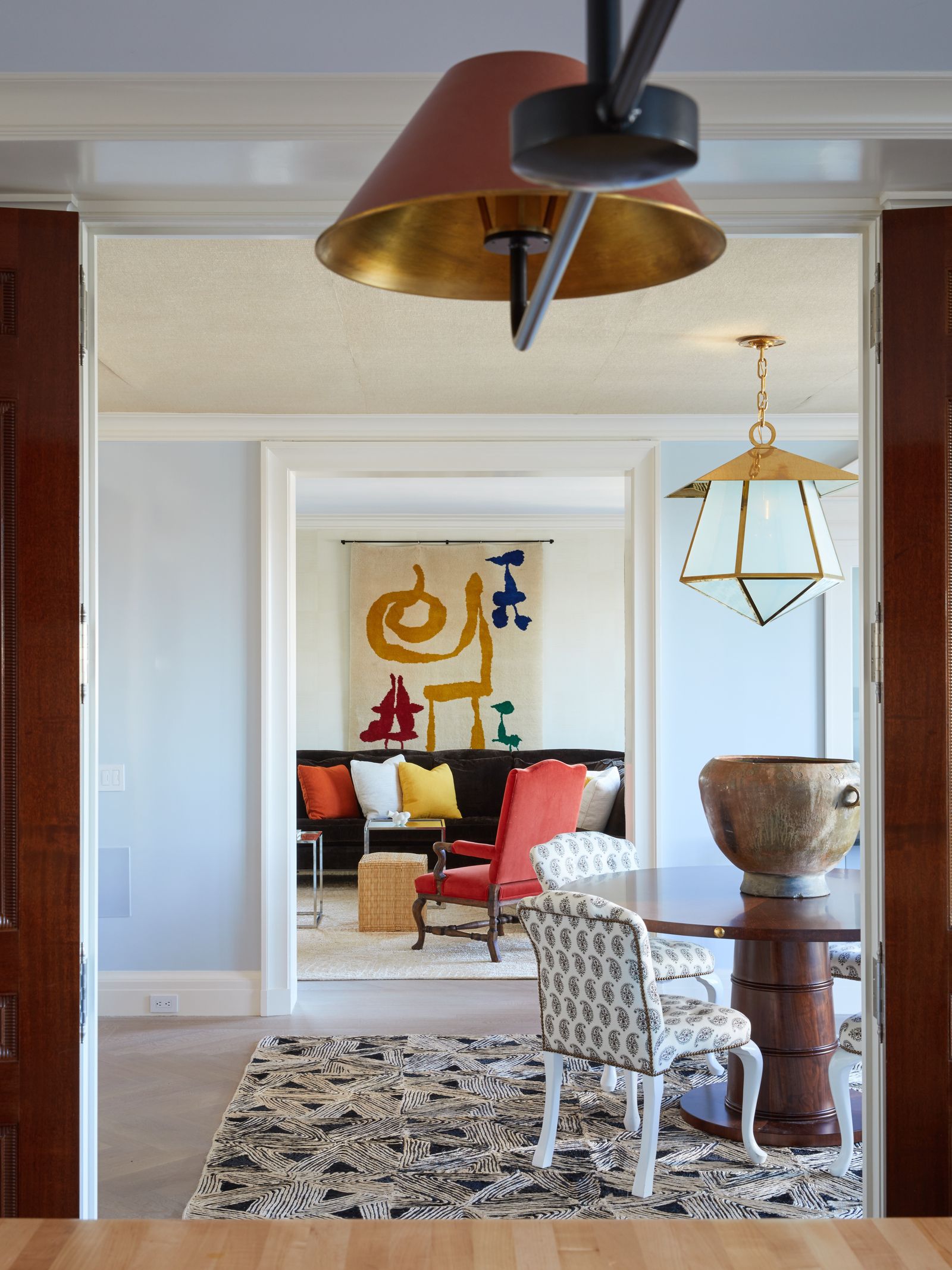 Upstairs in the original penthouse a view from the kitchen through the dining room to the living room where a Miro...