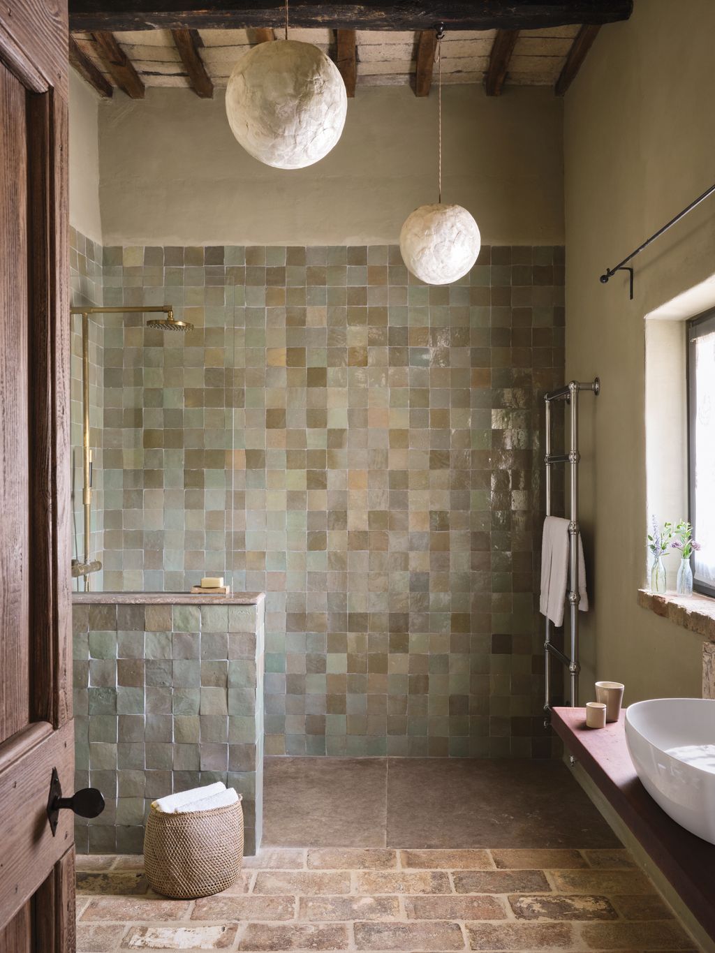 Motherofpearl balloon pendants stand out against Emery  Cie zellige tiles in this Italian bathroom. The tiles also...