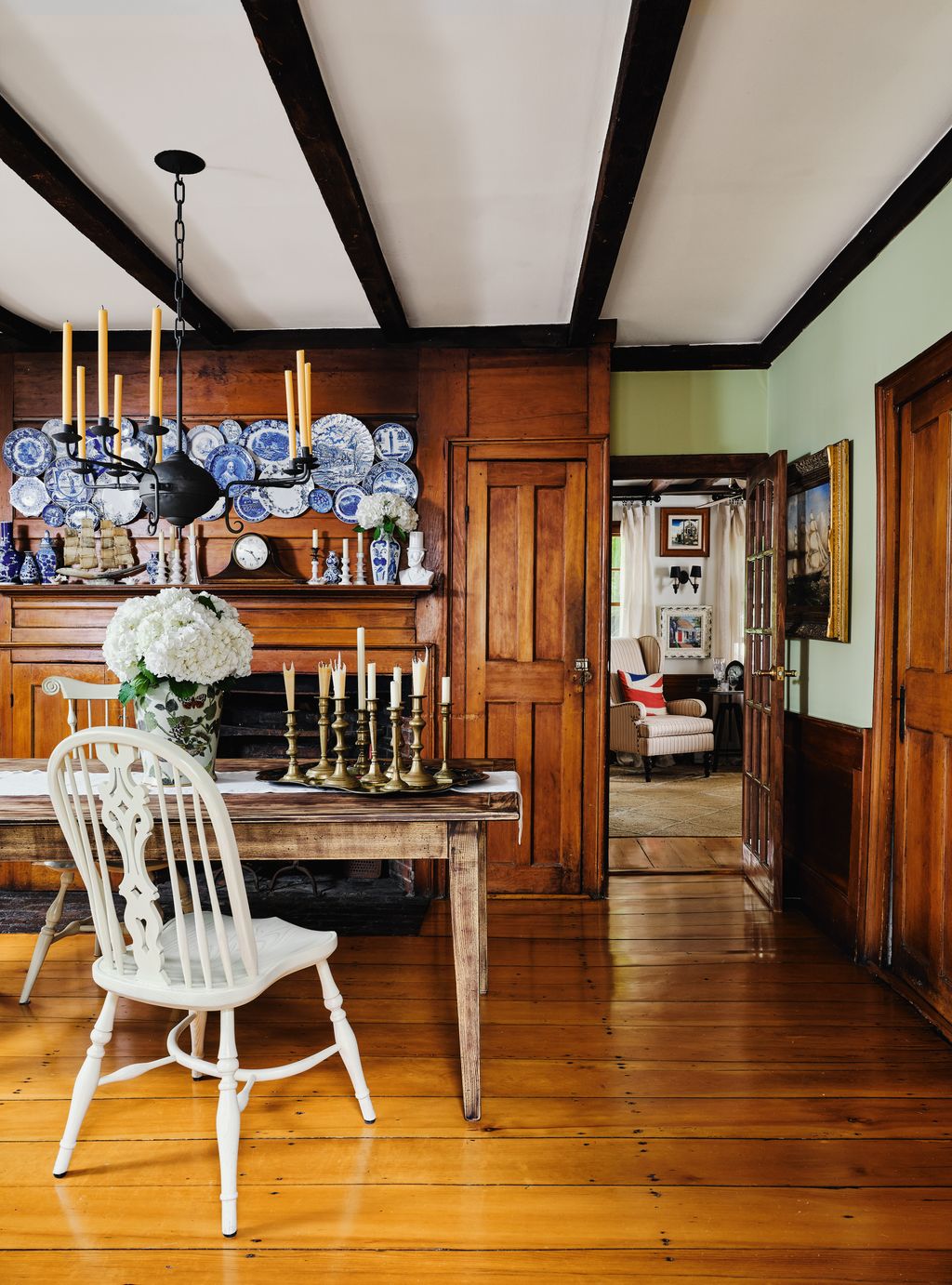 Antique plates are displayed on the original pine panelling of their dining room.