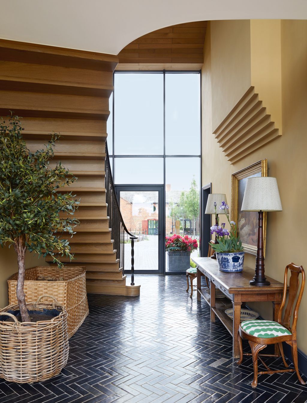Dark Lapicida tiles contrast with walls in Edward Bulmers ‘Trumpington in this grand modern hallway of a 19thcentury...