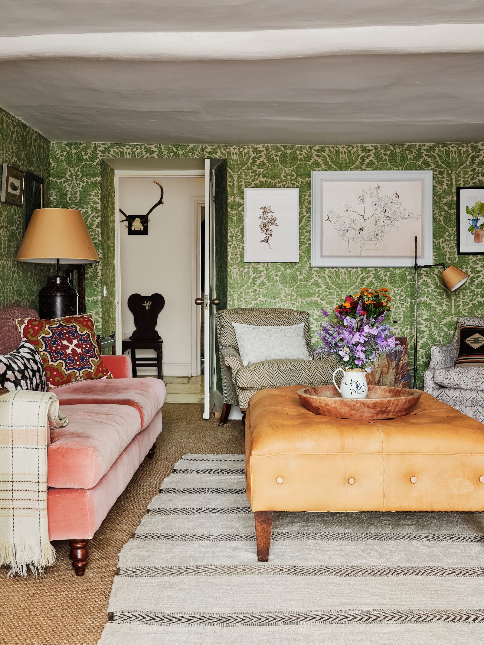 In the snug the botanical art is grouped together. On the wall at the end of the room hangs a Sarah Graham and Ishbel...