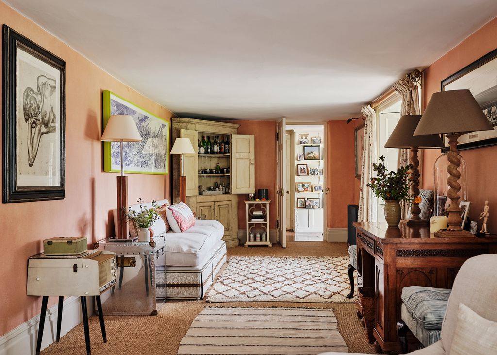 On the other side of the room a Grayson Perry hangs above a sofa from Robert Kime.