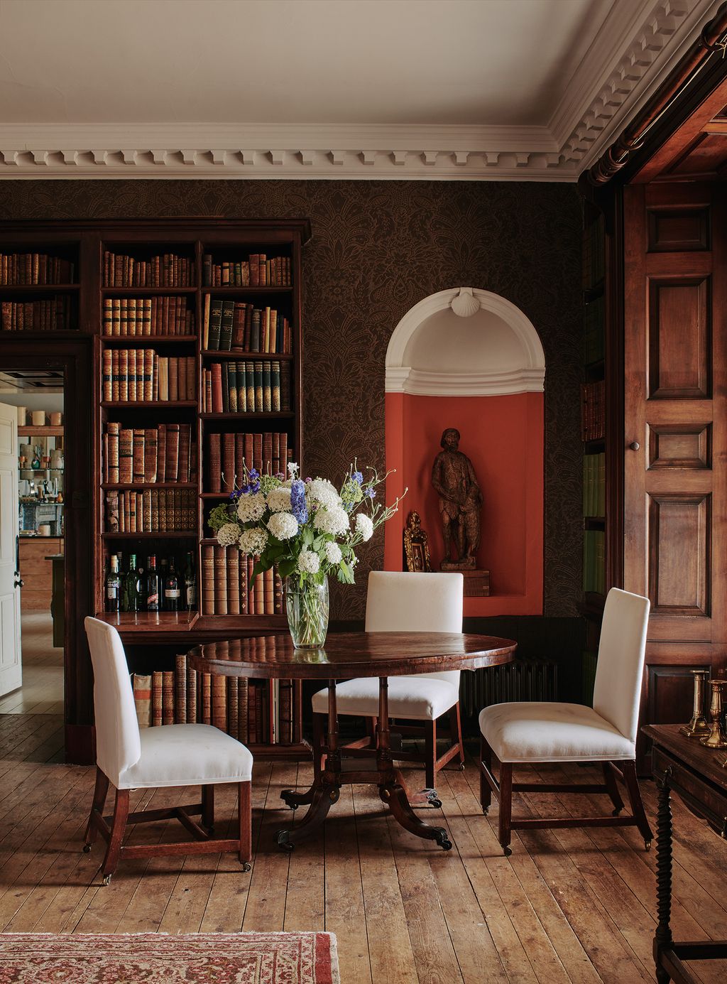 In the library at Wolterton Hall in Norfolk two panels of faux book spines on either side of a door drop down to reveal...