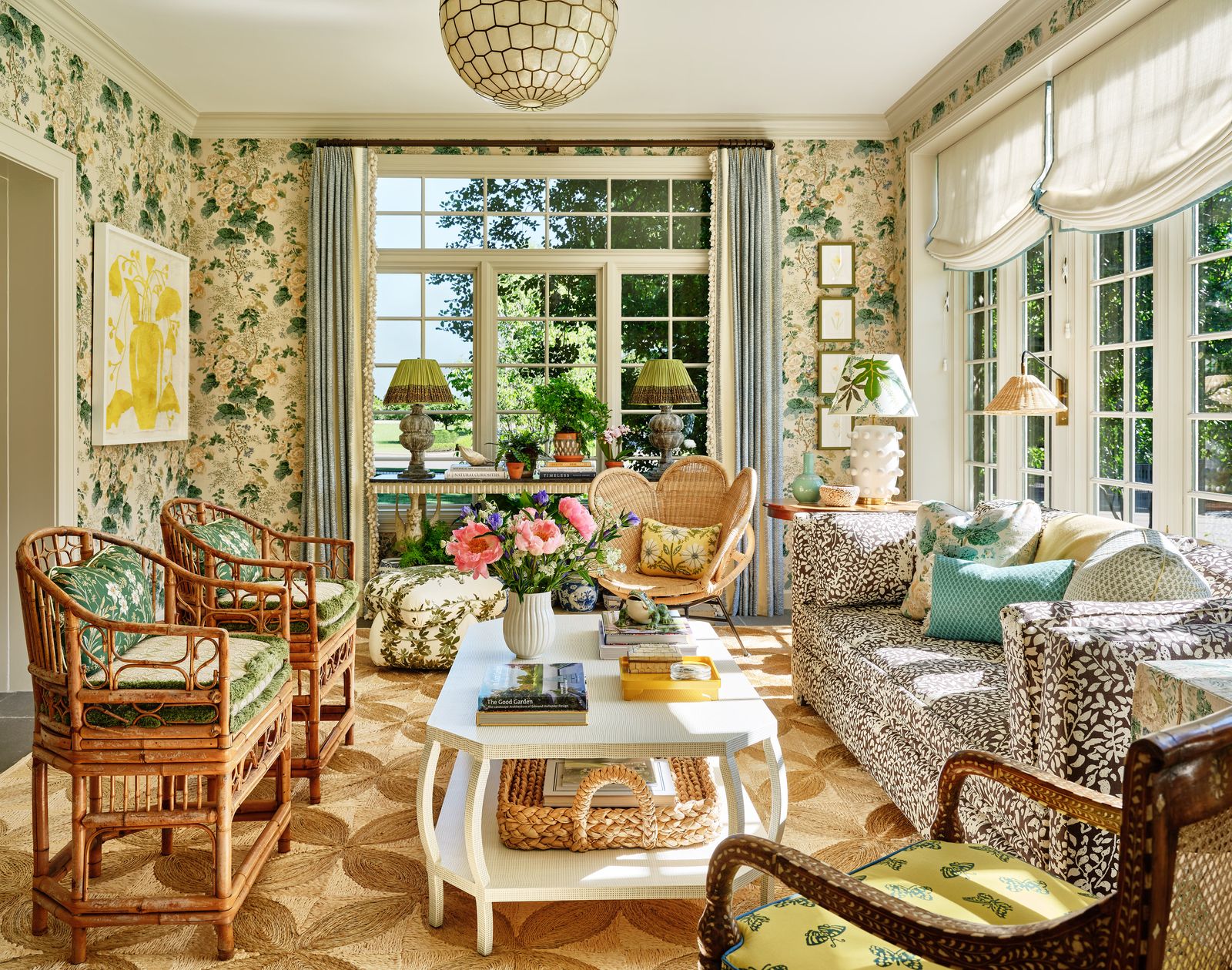 ‘Hollyhock sets the tone in the sunroom with a mix of antique finds and beloved fabrics making it a vibrant space.