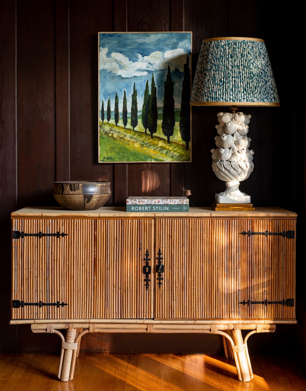 A vintagenbspAudouxMinet console sits under a painting by Antonella Radi. The vintage pomegranate lamp has anbspPenny...
