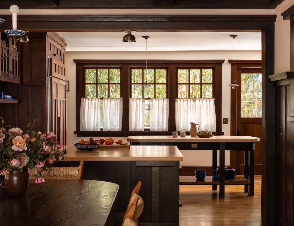 Sheer cafe curtains with a subtle floral motif cover the windows of this Berkeley house.