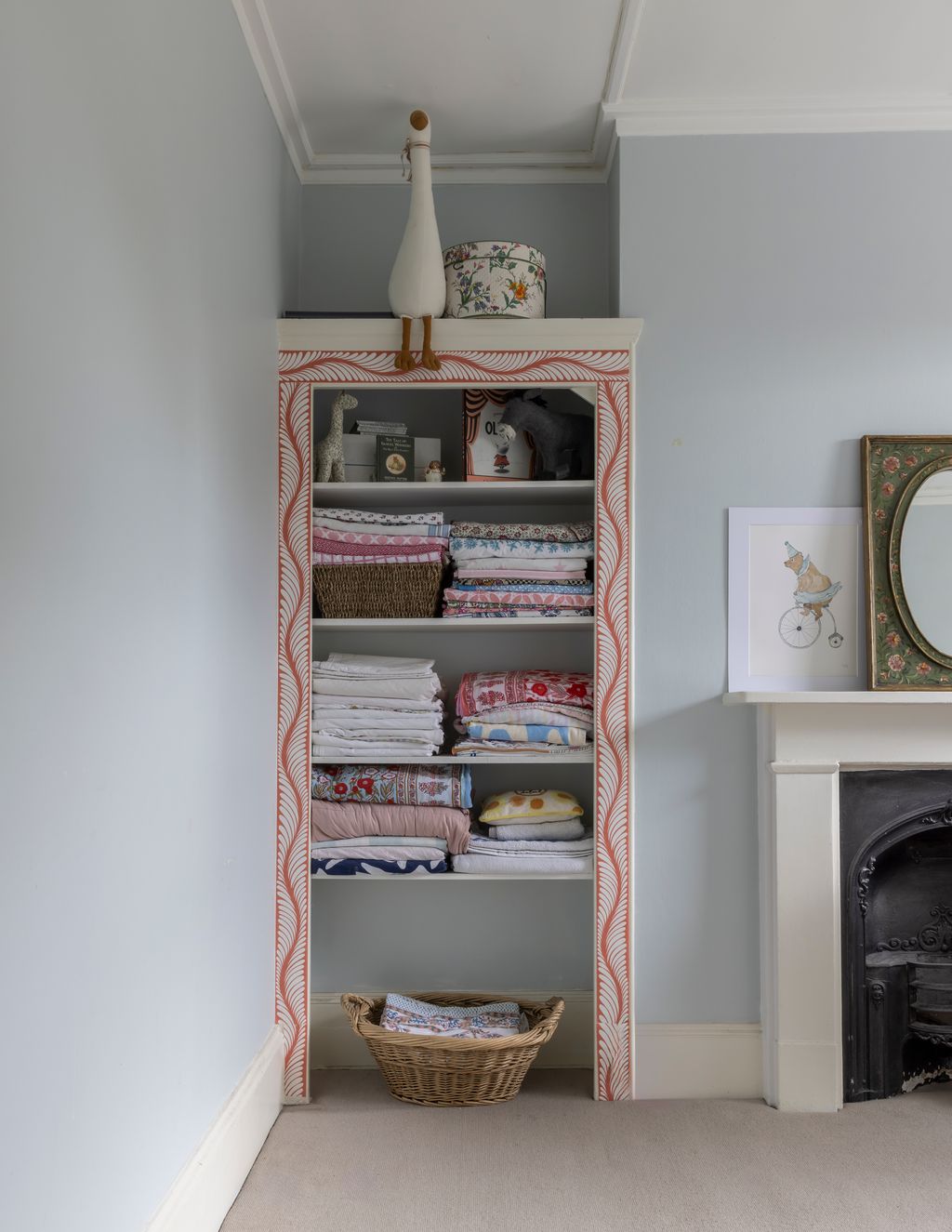 In this pale blue bedroom the scallop wallpaper edging is by Fiona Howard.