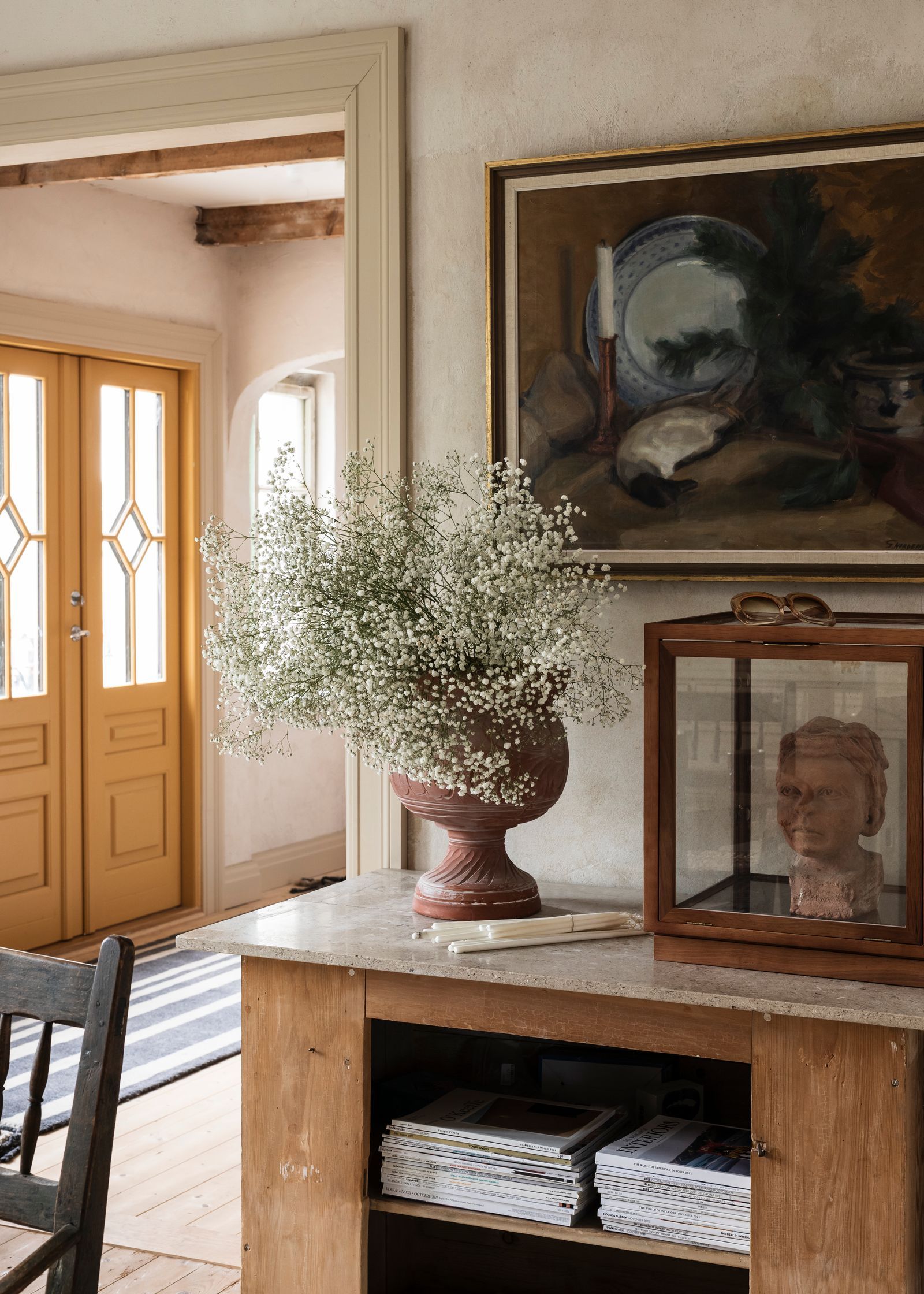 The cabinet is from a former candy store in Stockholm. The couple upgraded it with marble from the homes old...