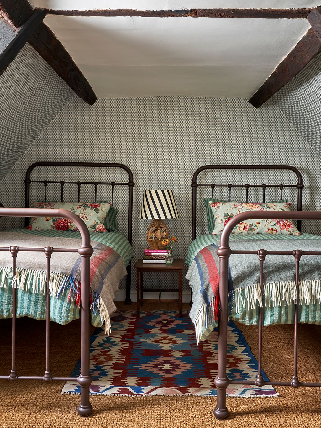 This is the only twin guest room in the house. The layered comfrotable feel is achieved by mixing florals and stripes...